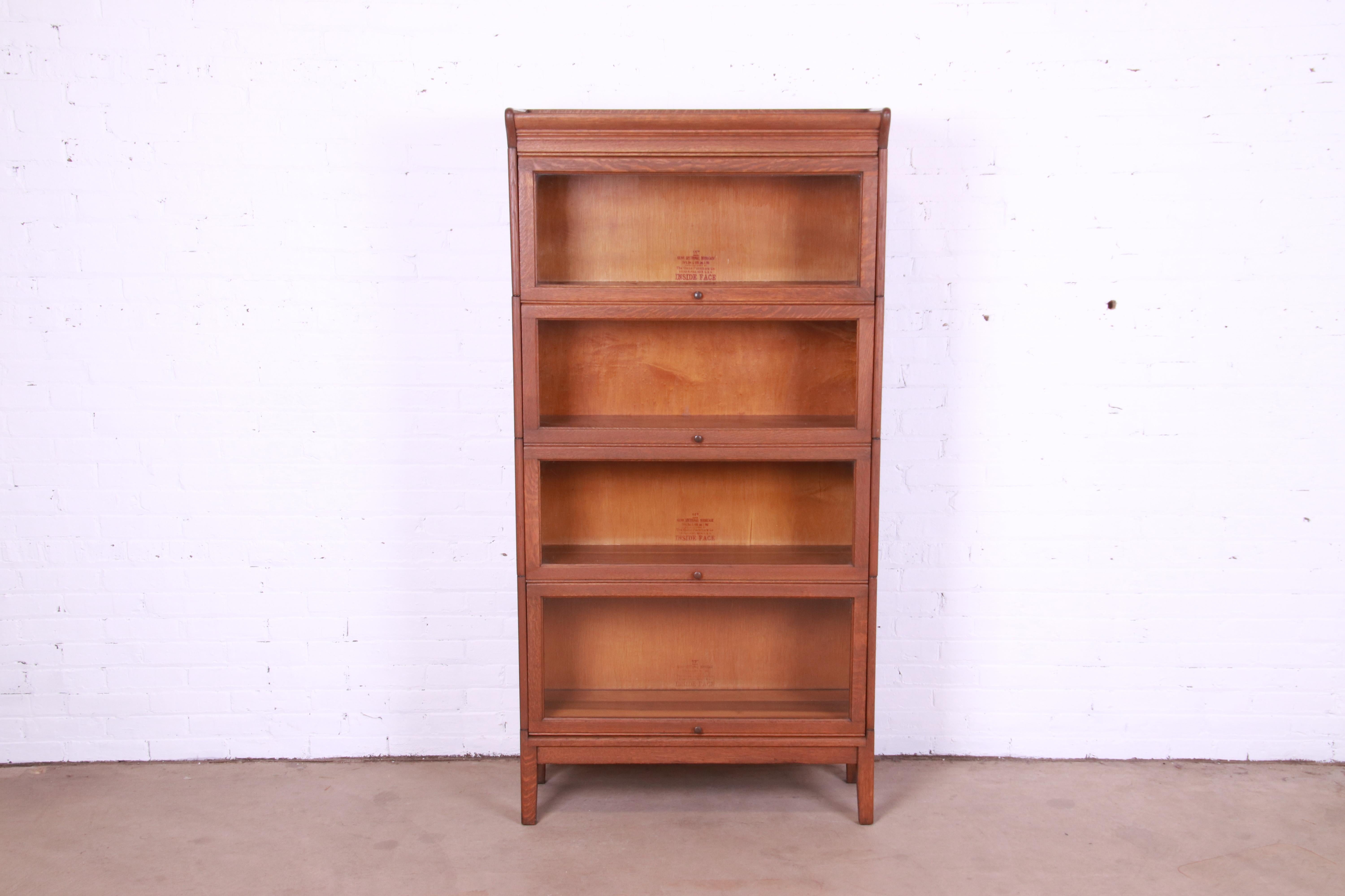 A gorgeous antique Arts & Crafts four-stack barrister bookcase

By Gunn Furniture Co.

USA, Circa 1920s

Quarter sawn oak, with glass front doors and original brass hardware.

Measures: 34.25