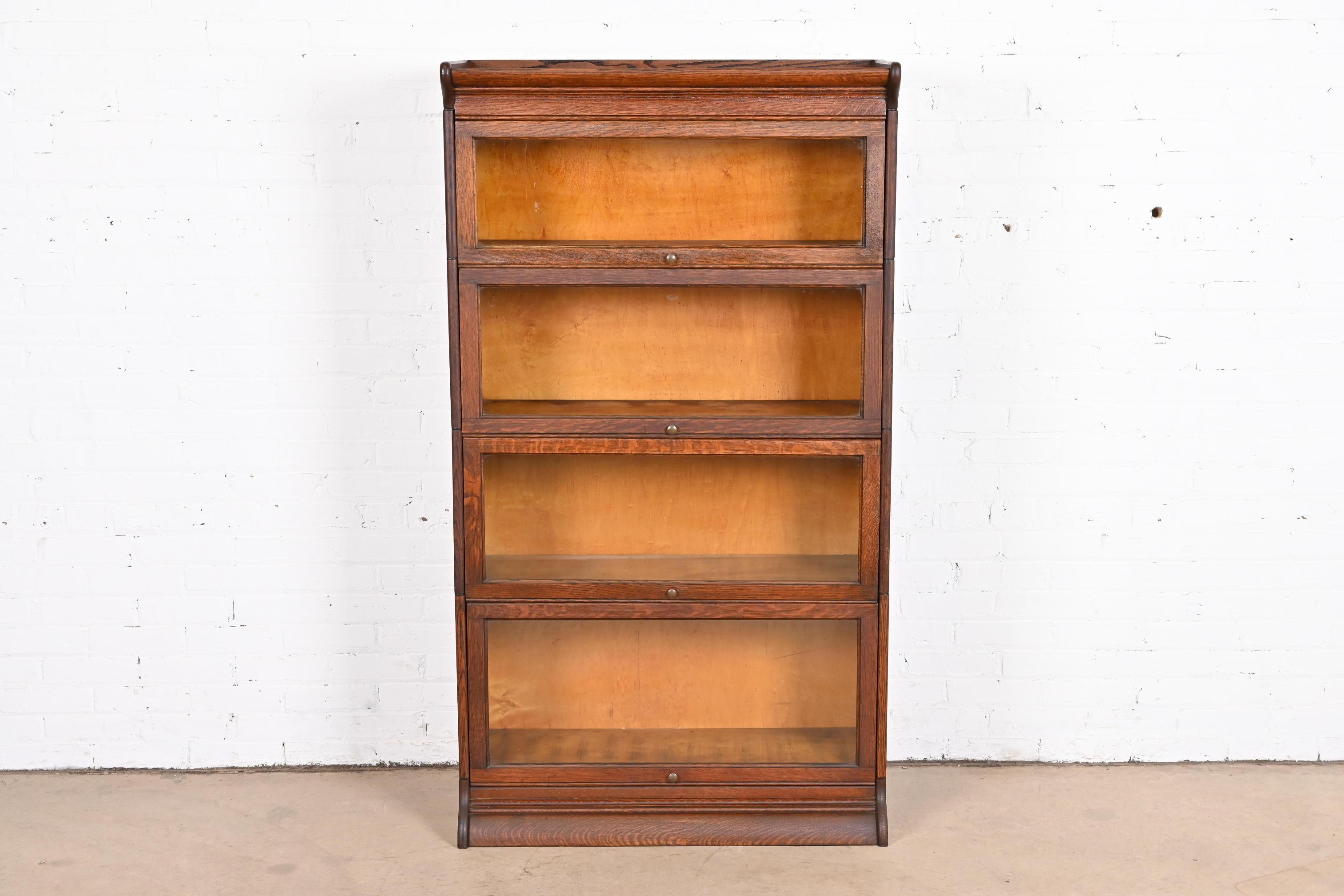 A gorgeous antique Arts & Crafts four-stack barrister bookcase

By Gunn Furniture Co.

USA, circa 1920s

Quarter sawn oak, with glass front doors and original brass hardware.

Measures: 34.25