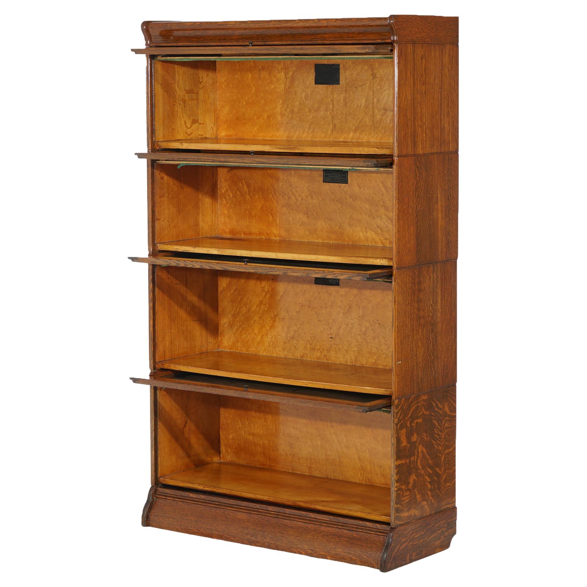 An antique Arts & Crafts barrister bookcase by Hale offers oak construction with four stacks, each having pull out glass doors, raised on an ogee base, maker label as photographed, circa 1910

Measures - 58.25 x 38.25 x 14