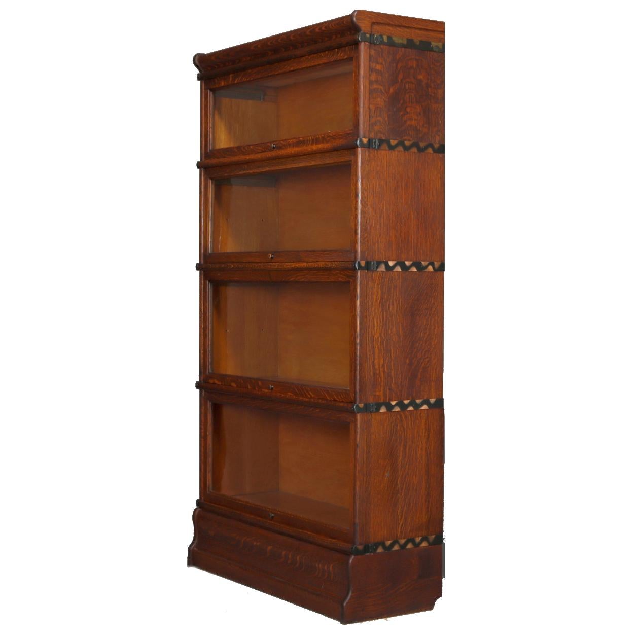 An antique Arts & Crafts Barrister bookcase by Macey offers quarter sawn oak construction with four stacks having pull out glass doors, original maker stamp as photographed, circa 1910.

Measures: 61.5