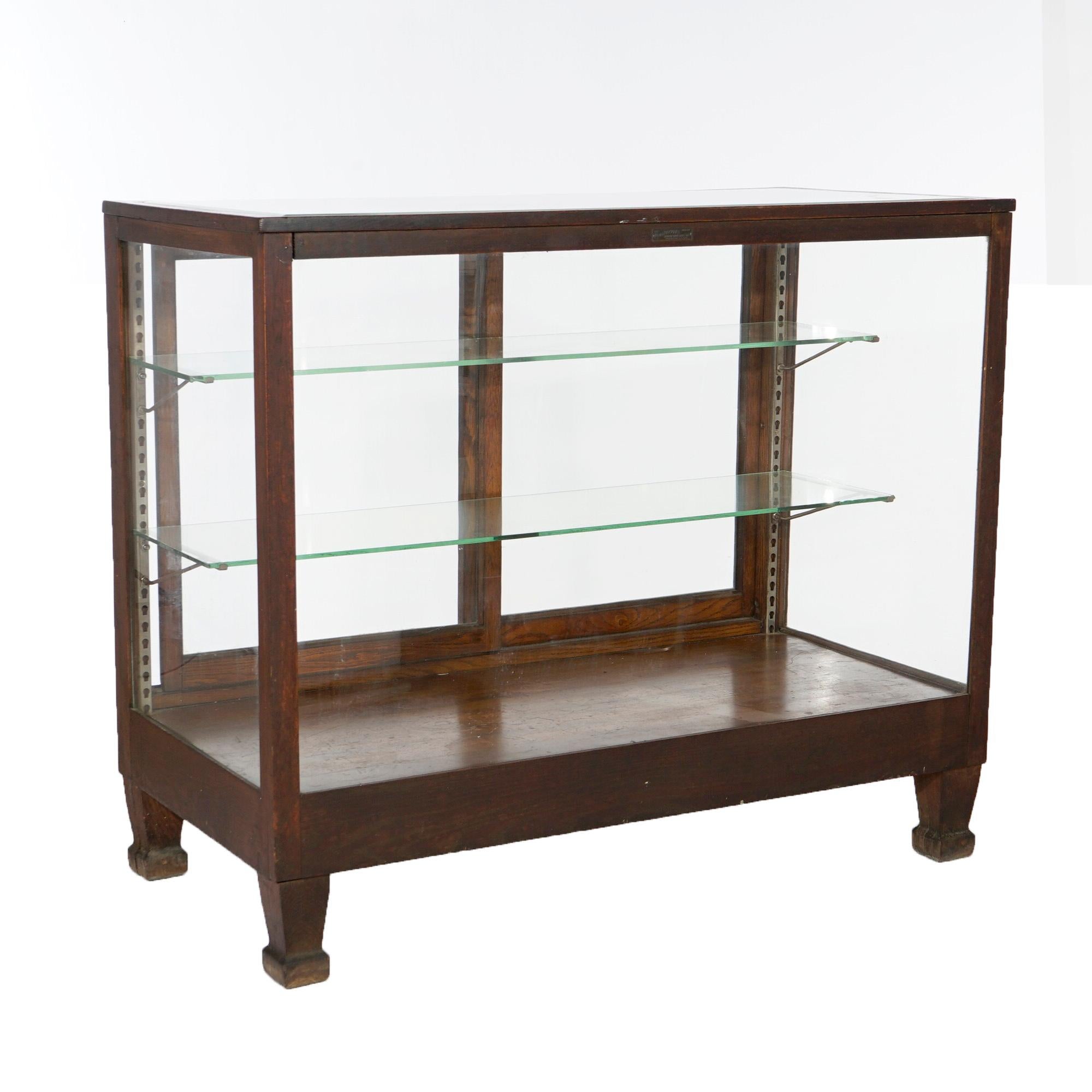 An antique Arts and Crafts country store counter display case by Wilmarth offers oak frame with sliding doors opening to adjustable shelf interior, raise on square and tapered legs, c1900

Measures- 42.25'' H x 48'' W x 25'' D.

*Ask about