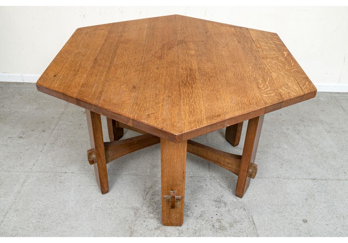 An original condition Dining/ Center Table in original condition with pegged construction, handsome graining and fantastic period Arts and Crafts style. Gently tapered base stretchers contrast beautifully with the straight plank legs and are