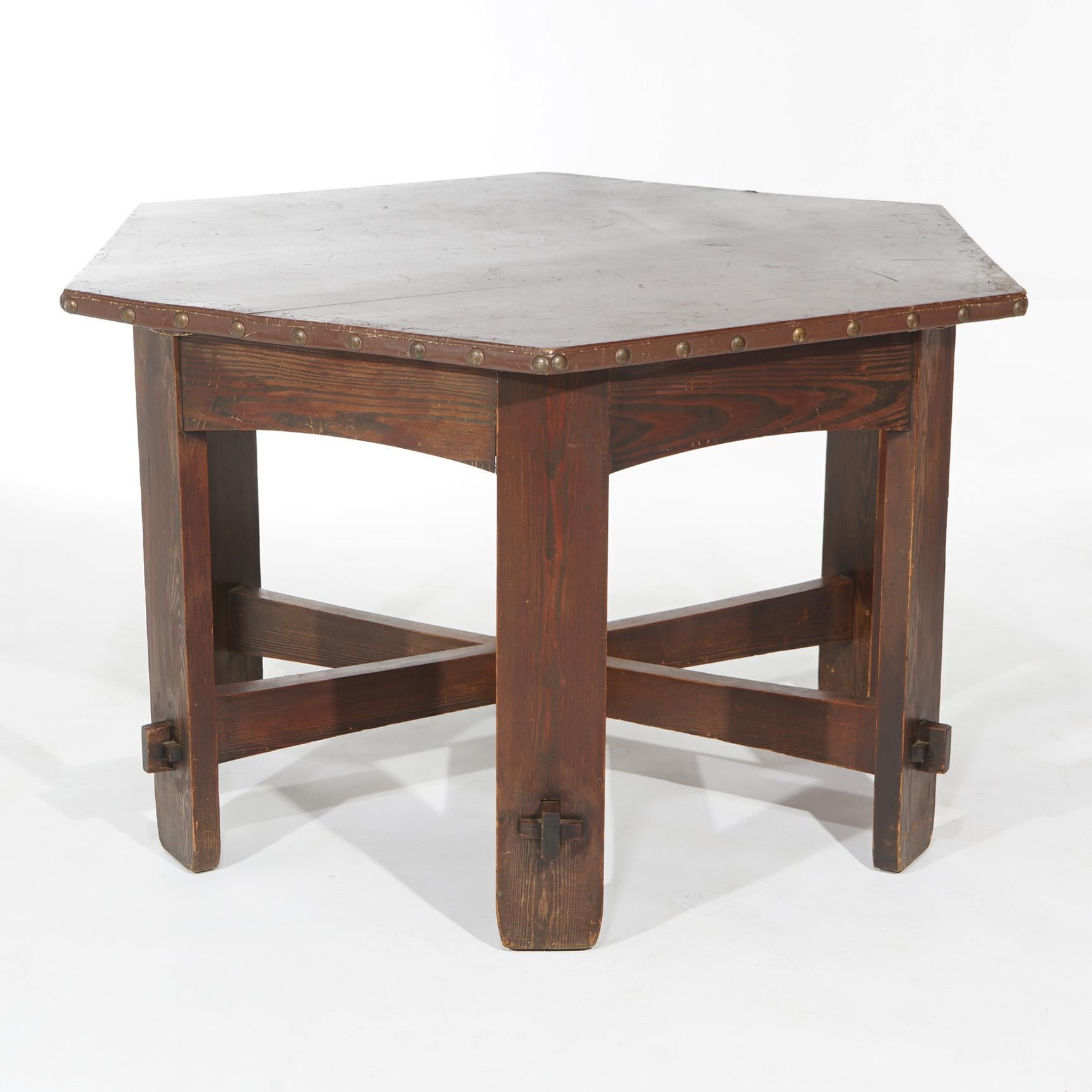 An antique Arts & Crafts L&JG Stickley Onondaga Shop dining table offers chestnut construction with octagonal leather covered top over mortise and tenon base, circa 1910

Measures - 30.5