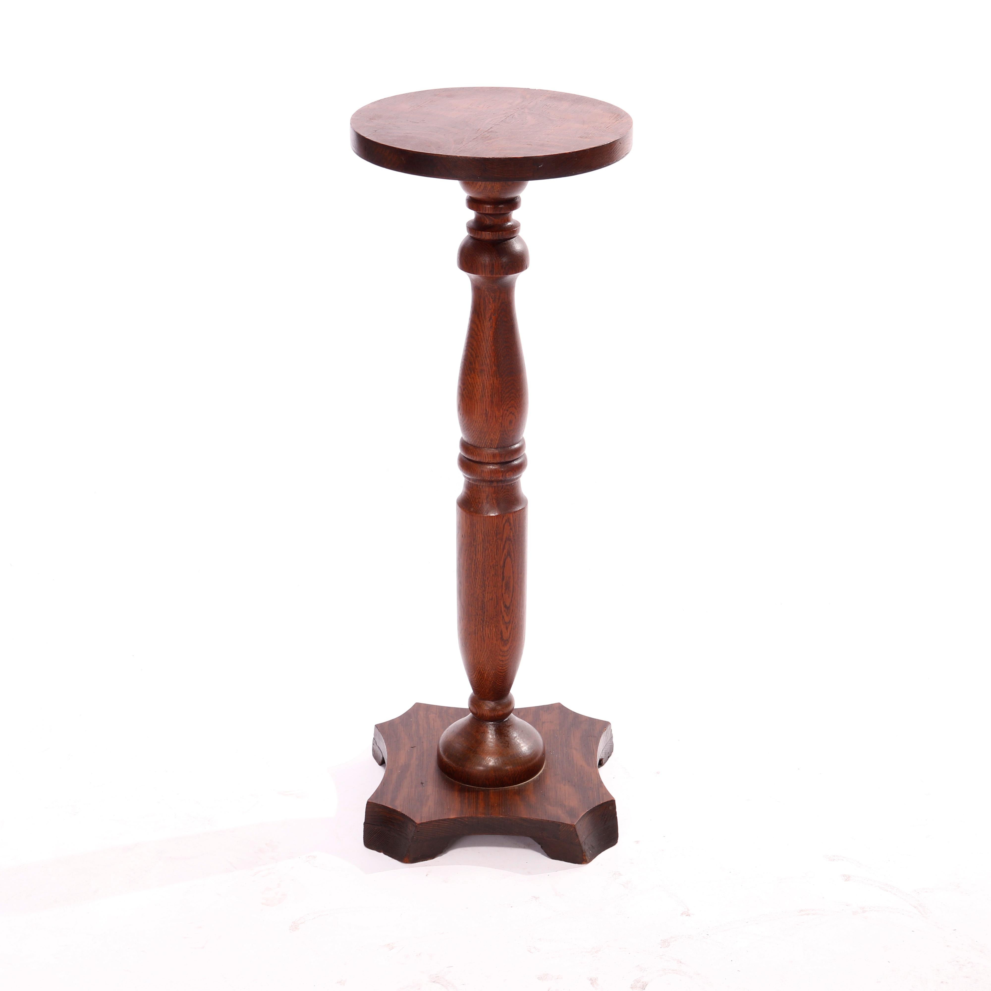 An antique Arts & Crafts pedestal offers oak construction with round display over turned balustrade column, c1910

Measures - 34.25'' H x 14.75'' W x 14.75'' D.

Catalogue Note: Ask about DISCOUNTED DELIVERY RATES available to most regions within