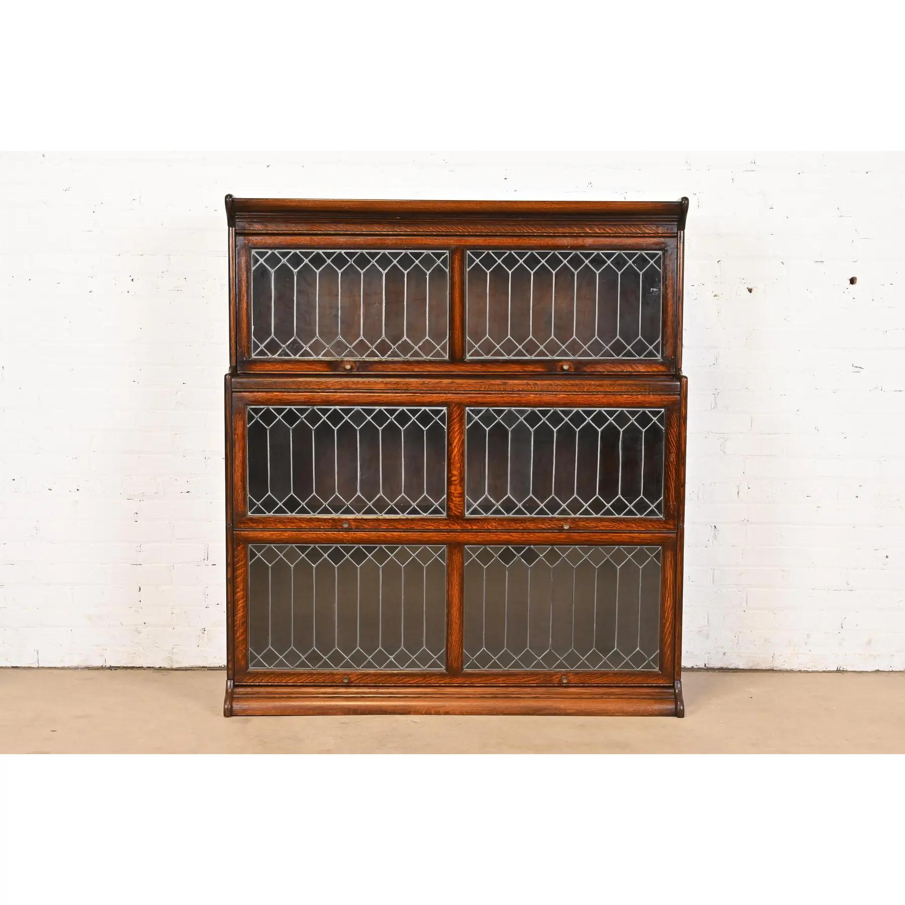A gorgeous antique Arts & Crafts three-stack barrister bookcase

Attributed to Globe Wernicke

USA, Circa 1900

Quarter sawn oak, with leaded glass doors, and brass hardware.

Measures: 50.5