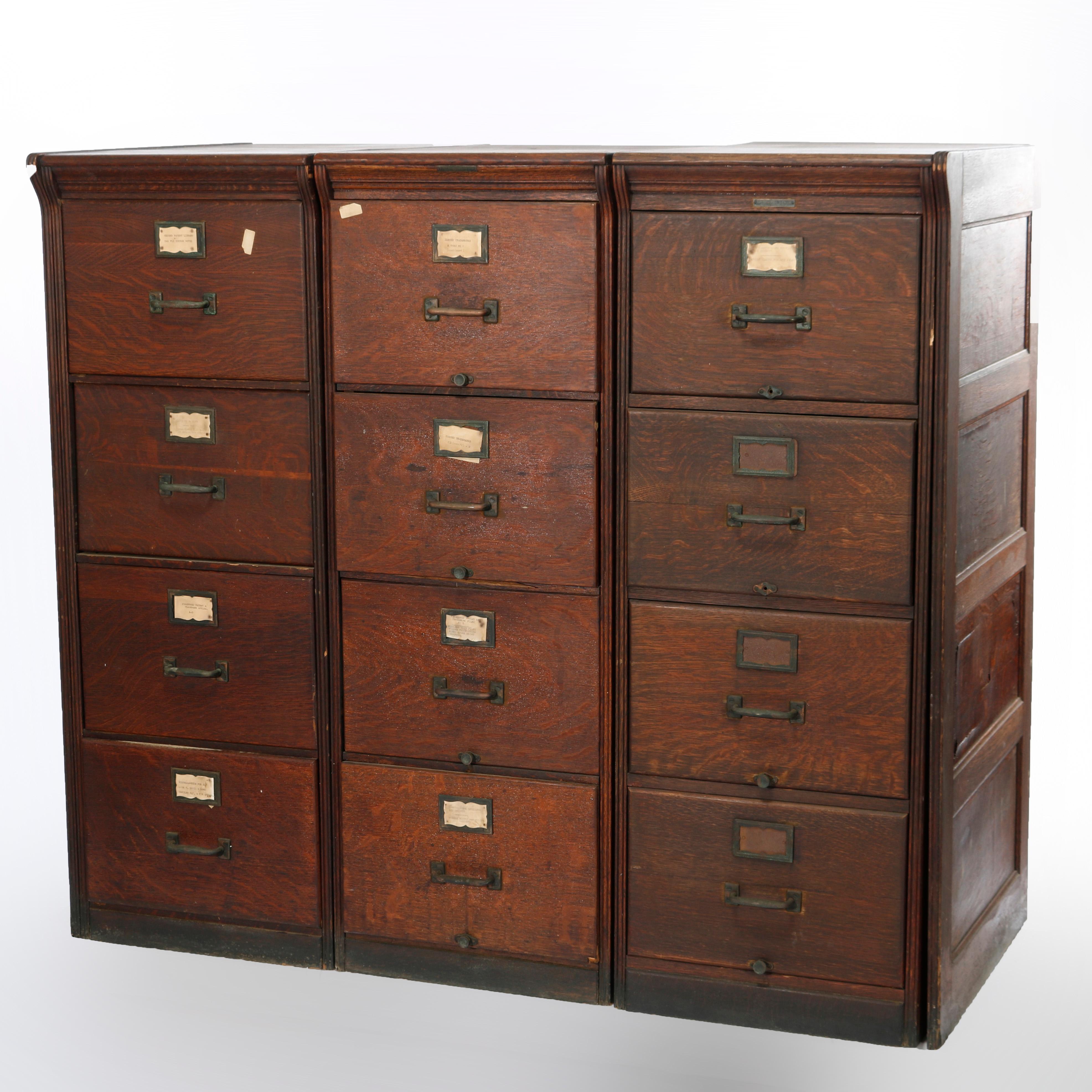 An antique triple filing cabinet by Yawman and Erbe offers quarter sawn oak construction with three sections (two legal and one standard), each having three drawers, maker label as photographed, c1910

Measures - 53''H x 59.5''W x