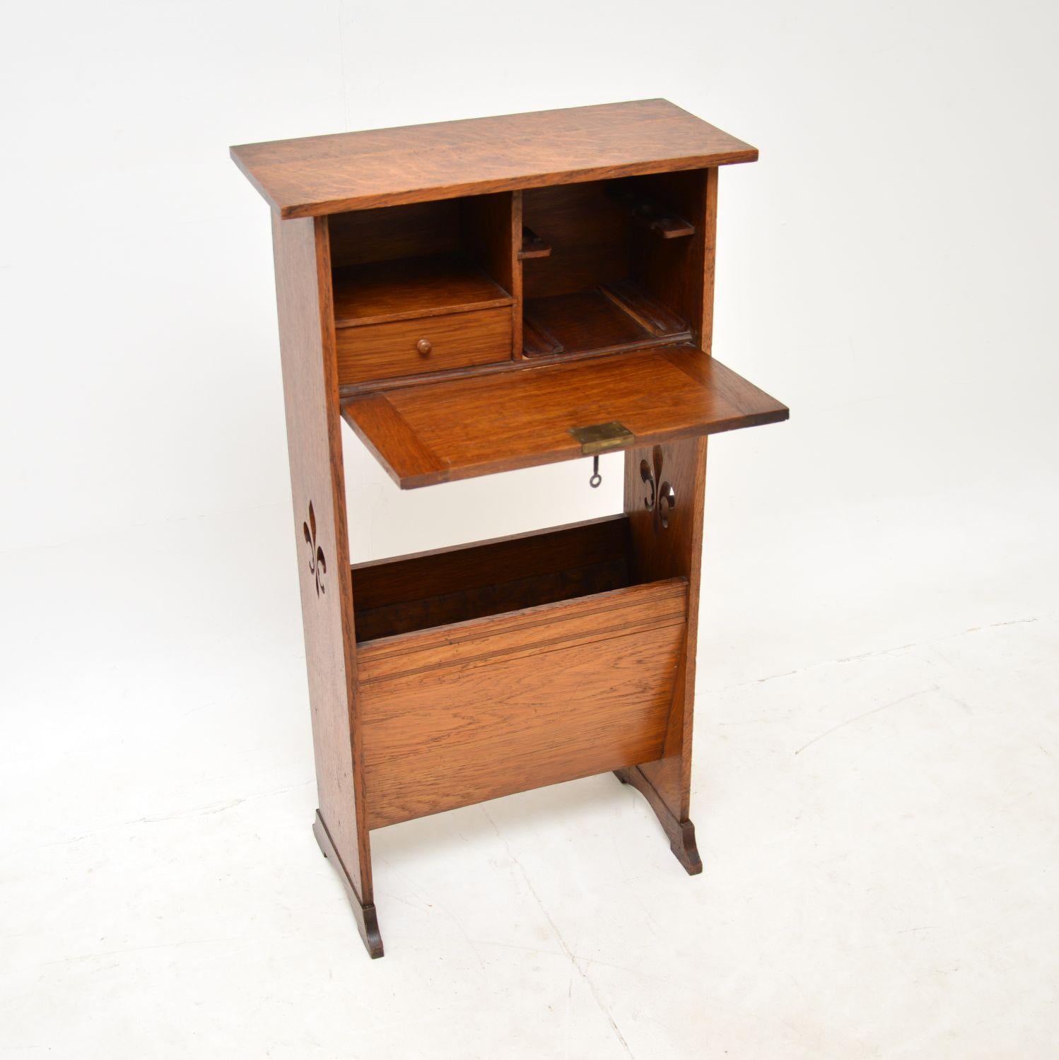 A beautiful and petite antique Arts & Crafts period writing bureau in oak. This was made in England, it dates from around 1880-90’s.

The size of the pull down work space is very small, meaning it’s probably not great for working at, but it is still