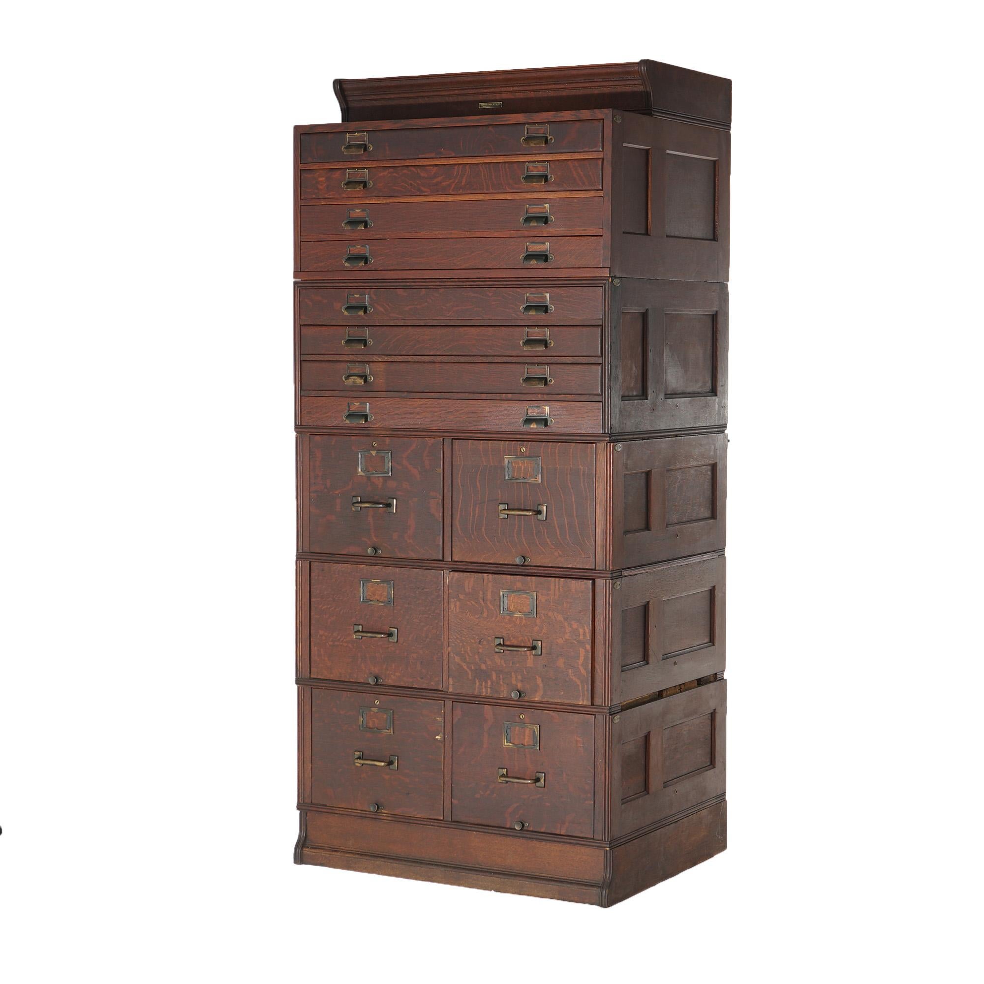An antique Arts and Crafts filing cabinet by Yawman and Erbe offers quarter sawn oak paneled construction with five stacks having file and map drawers, c1910

Measures - 74