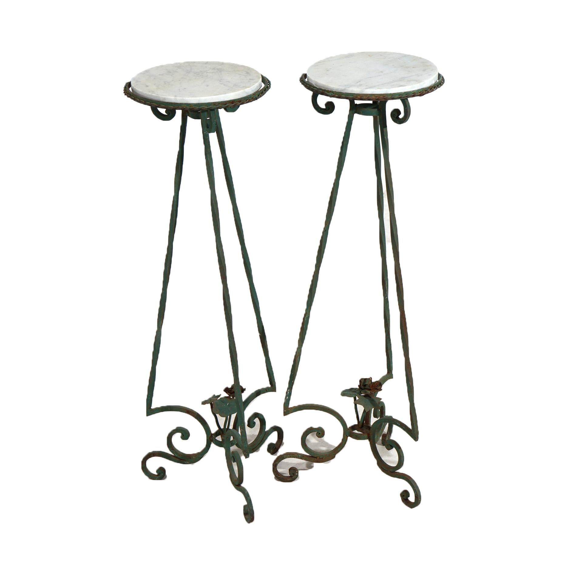 An antique pair of plant stands in the manner of Oscar Bach offer circular marble displays over wrought iron base having three stylized scroll form legs, c1920

Measures- 41.25''H x 15.5''W x 15.5''D