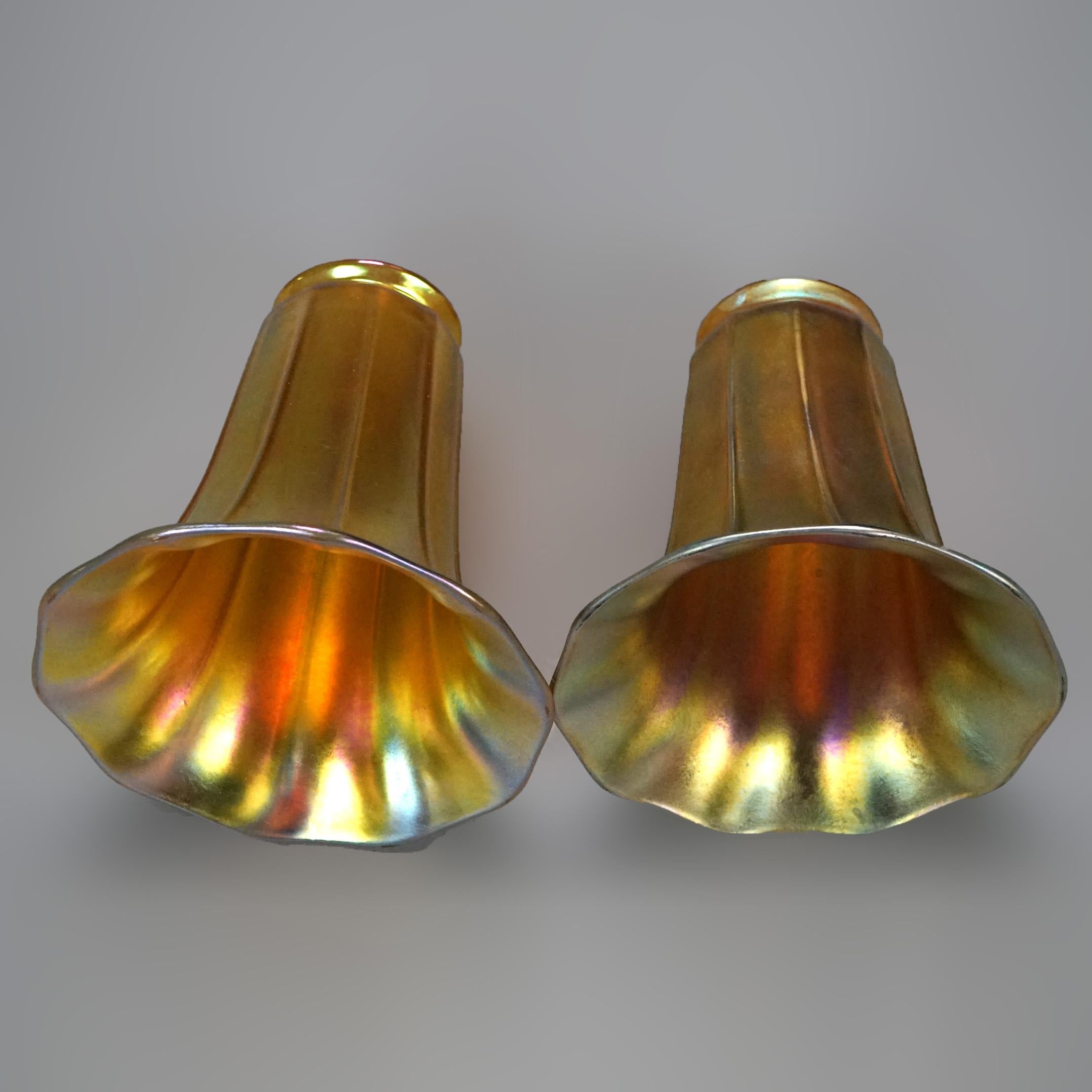 An antique pair of Arts and Crafts lamp shades by Steuben offer gold aurene art glass construction in tulip form with ribbed panels, c1920]

Measures- 5.25''H x 4.75''W x 4.75''D