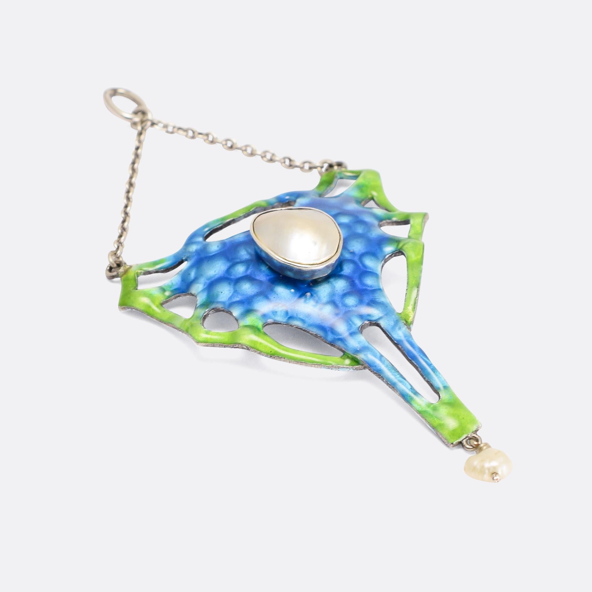A cool Arts & Crafts pendant dating from the late 19th Century. It's finished in vitreous blue and green enamel, and home to a mabe pearl in the centre, and a baroque pearl drop. The abstract shape is reminiscent of some sort of sea creature...