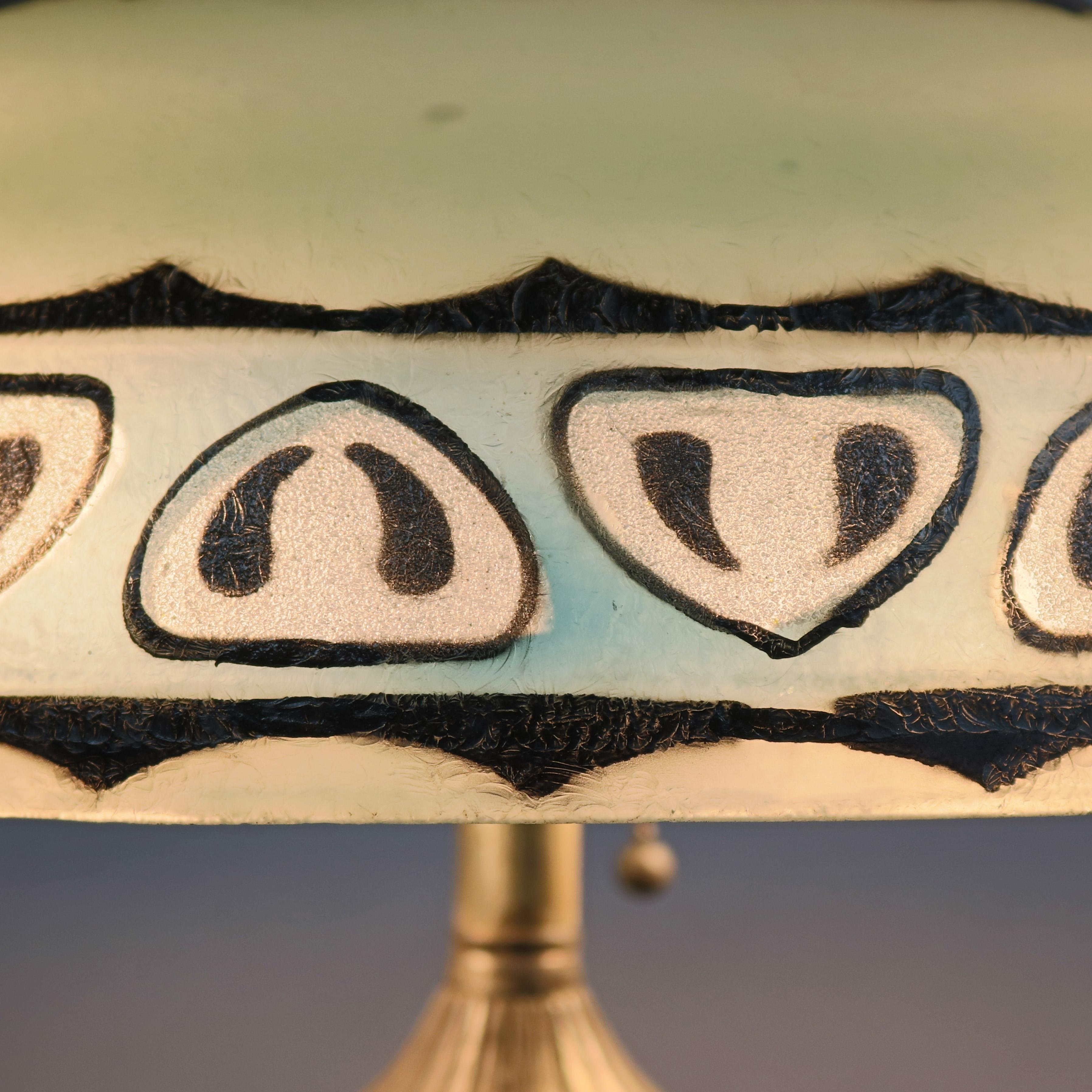 Arts & Crafts Pittsburgh lamp offers double socket base surmounted by shade with reverse painted shade with stylized band, circa 1920. 

Measures - 19.5\