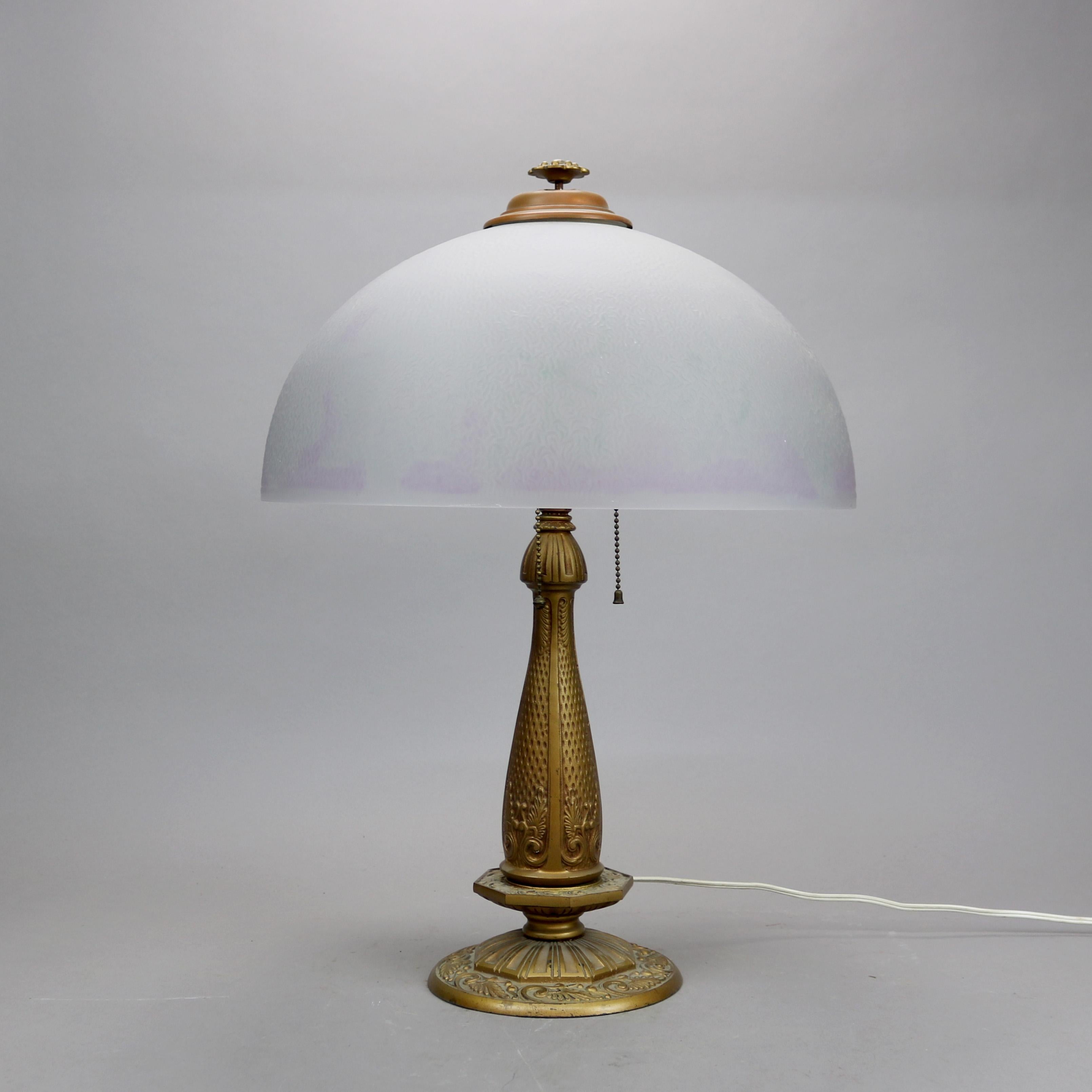An antique Arts & Crafts table lamp in the manner of Pittsburg Lamp Co. offers chipped ice glass dome shade over double socket cast base in the stylized floral form, embossed 1909 on base as photographed, c1920

Measures - 22.5''H X 16''W X 16''D.
