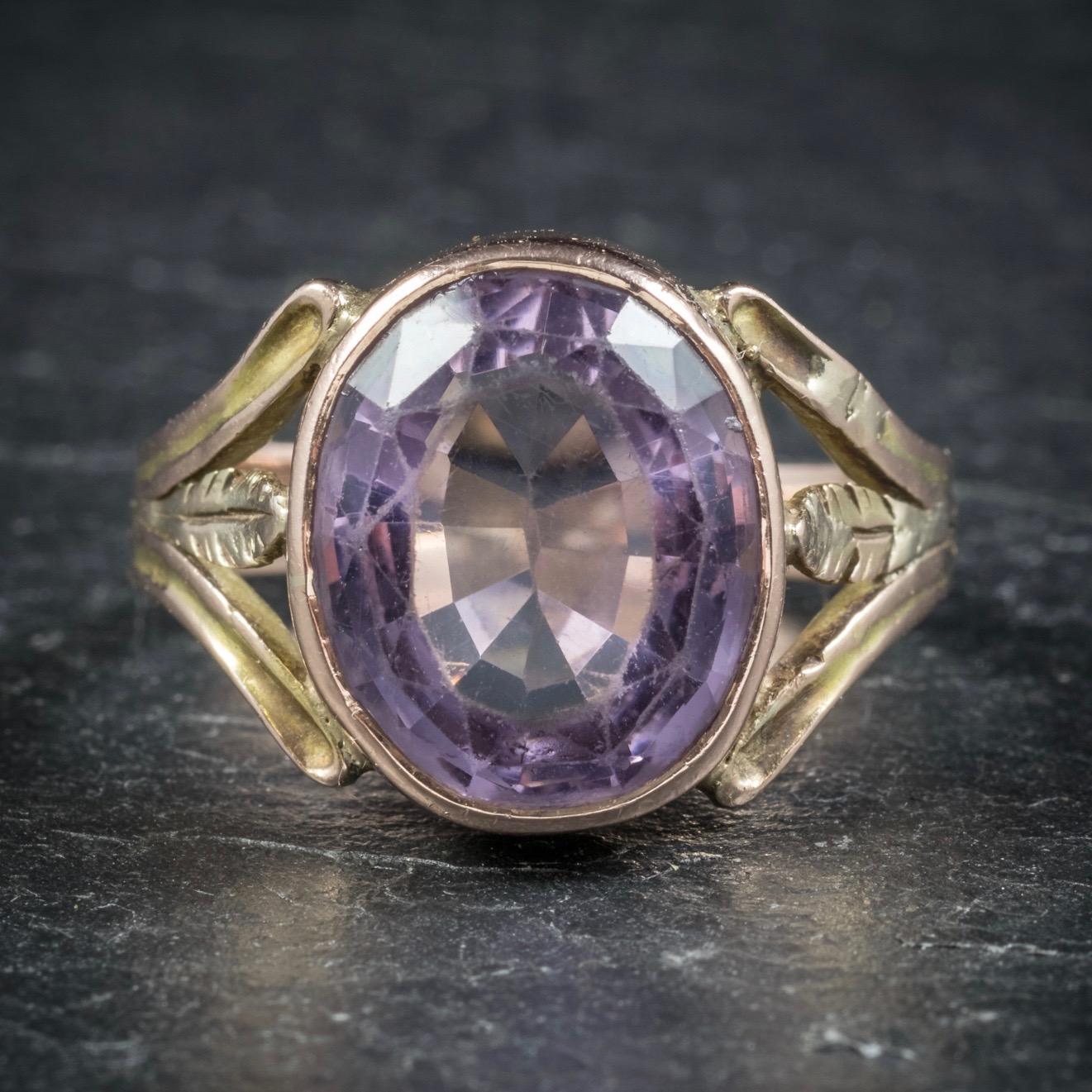This spectacular antique Arts and Crafts Spinel ring was beautifully made during the Victorian era, Circa 1900. 

Adorned with a large Spinel stone in the centre which is a lovely pale violet colour. 

The gallery is all 15ct Yellow Gold and boasts