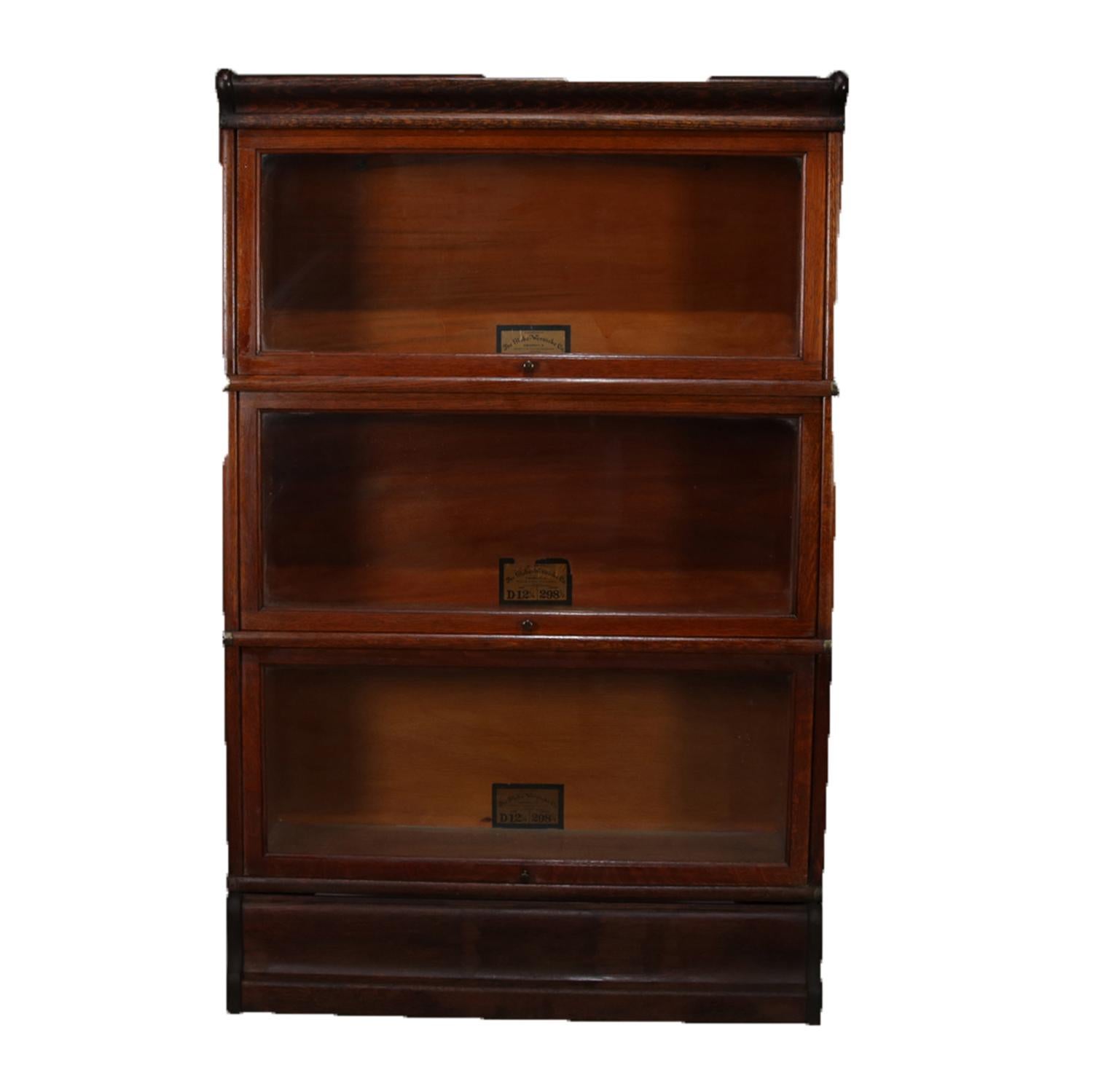 Antique Arts & Crafts Barrister bookcase by Globe-Wernicke Co. features quarter sawn oak construction with four stacks and pull-out glass doors, original labels, relevant to the legal profession and law offices, circa 1910.

Measures: 53.25