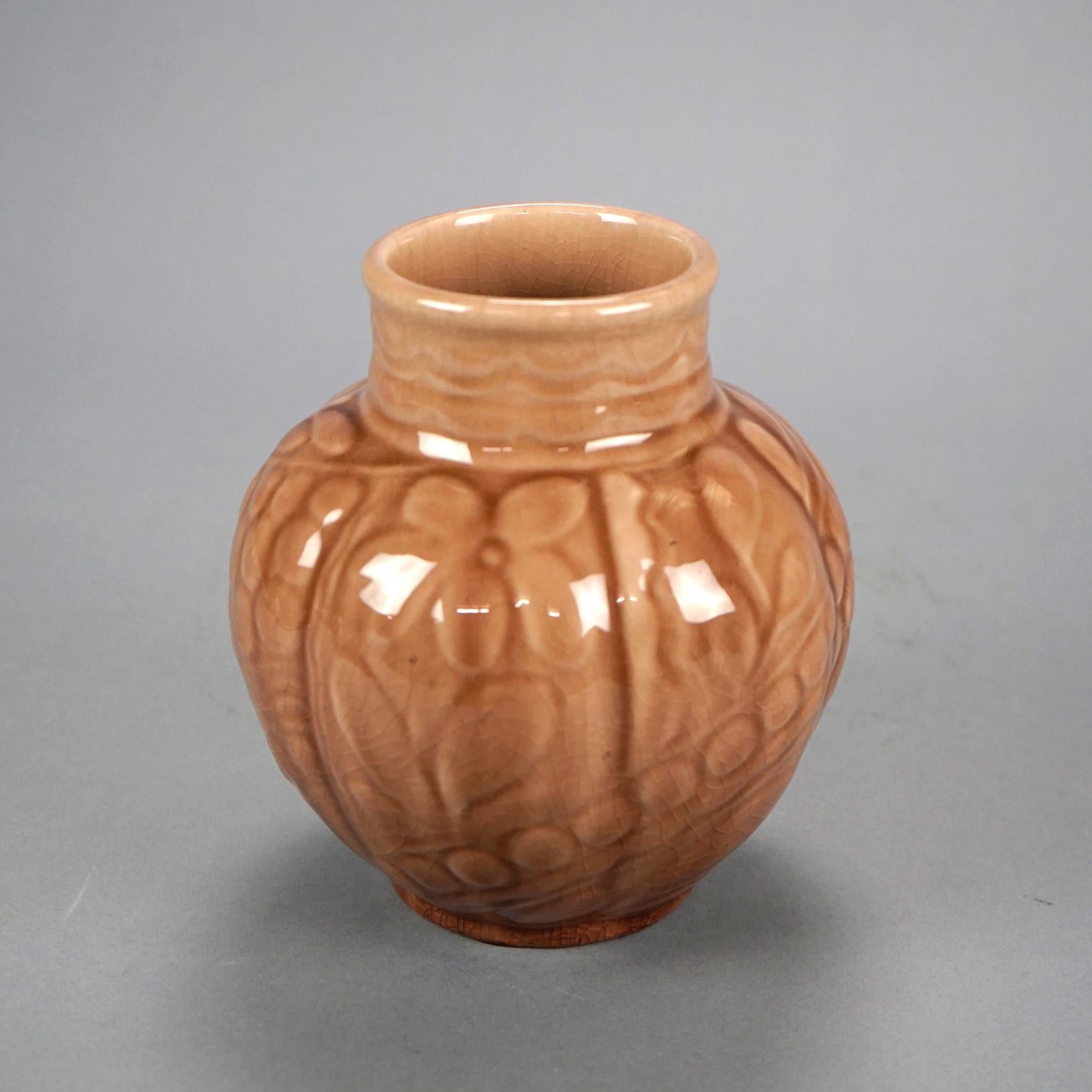 An antique Arts and Crafts vase by Rookwood offers art pottery construction in melon form and having stylized incised flowers and high glaze, 1944.

Measures- 6.75'' H x 6'' W x 6'' D.

Catalogue Note: Ask about DISCOUNTED DELIVERY RATES available