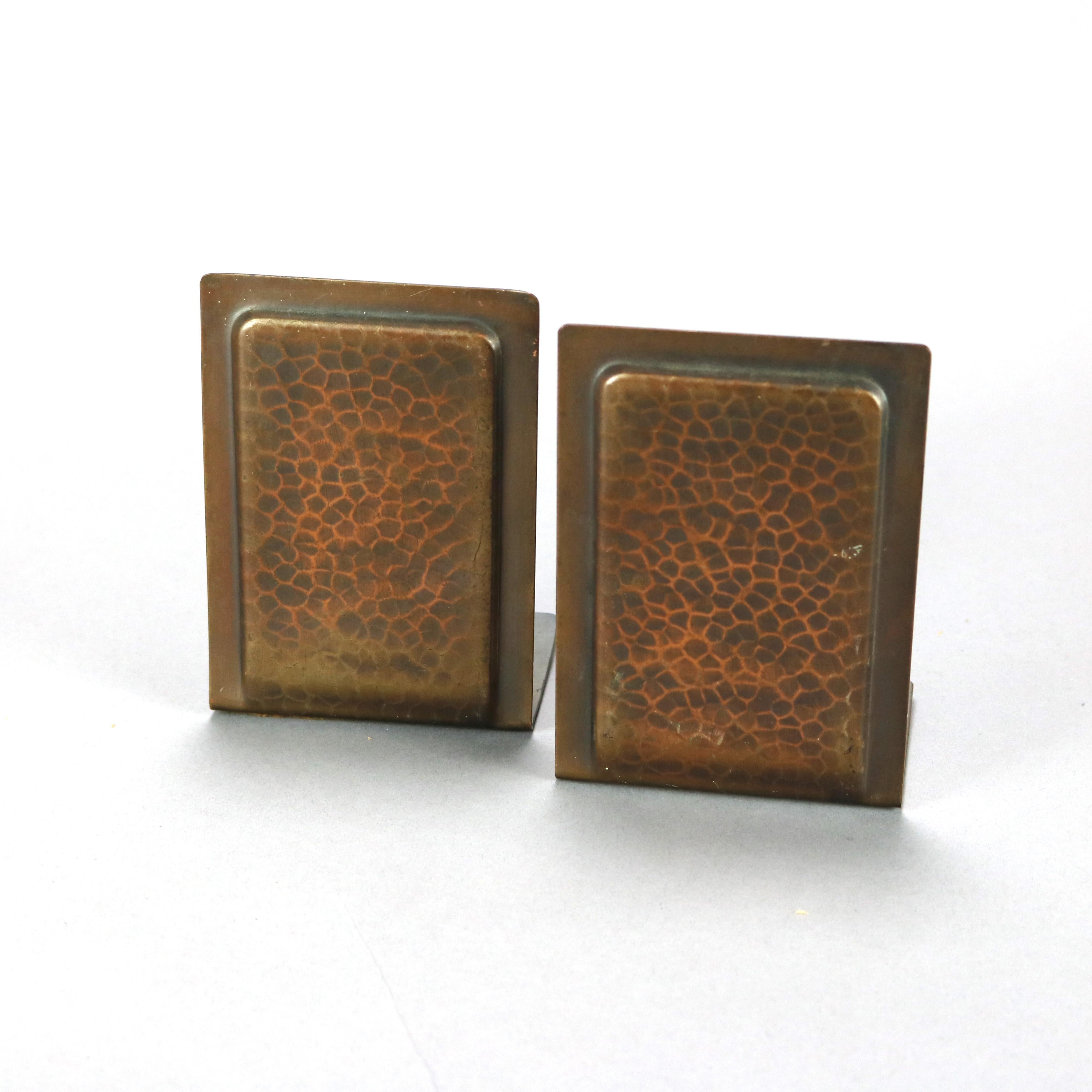 An antique Arts and Crafts set of bookends by Roycroft offer hammered copper construction with raised panels and maker mark as photographed, c1910

Measures - 5.25''H x 3.5''W x 2.75''D.