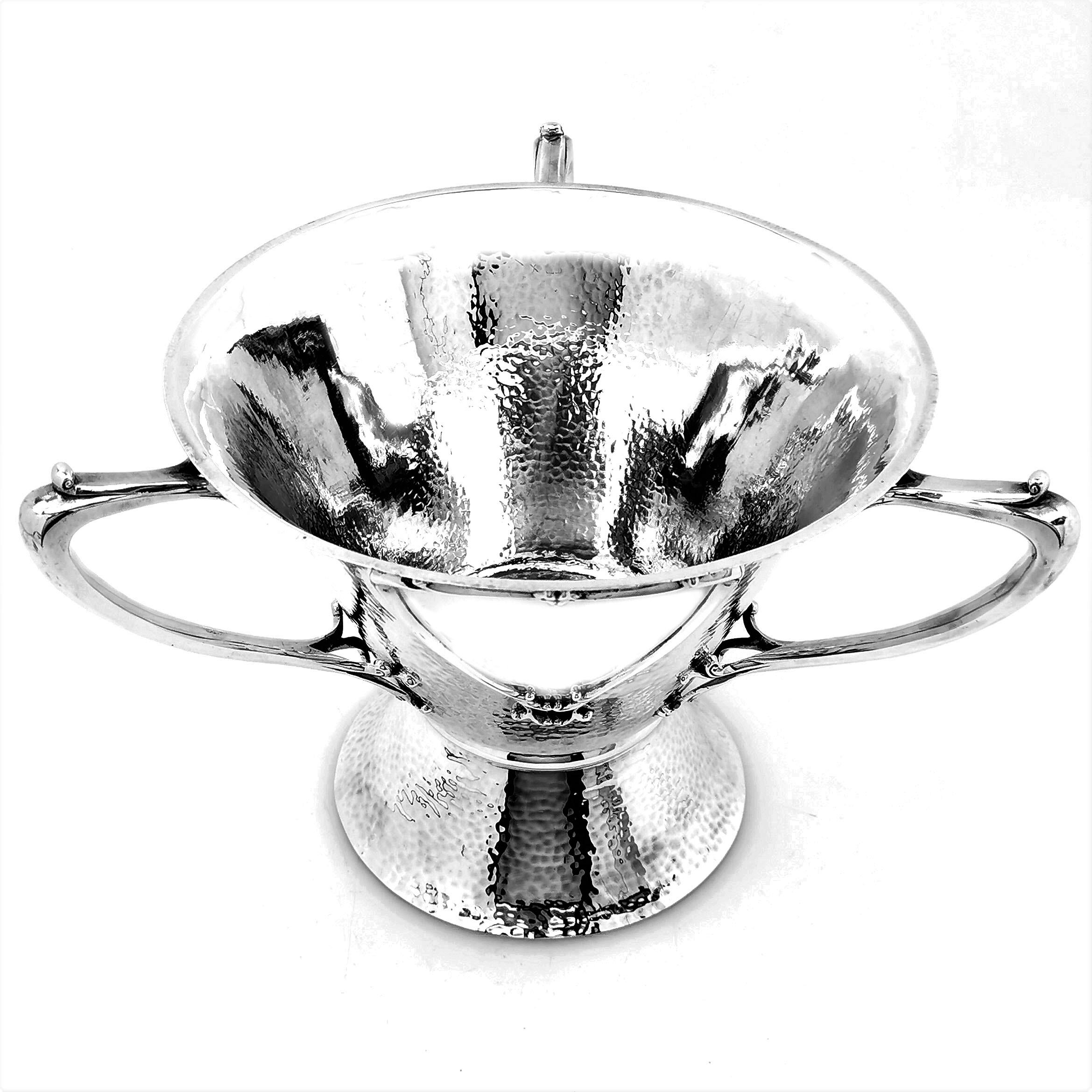 A beautiful Antique Arts & Crafts Scottish Silver three handled Cup in an elegant Arts & Crafts design. The Loving Cup has three elegant handles with shaped polished cartouches between each one. The rest of the body and spread foot have a hammered
