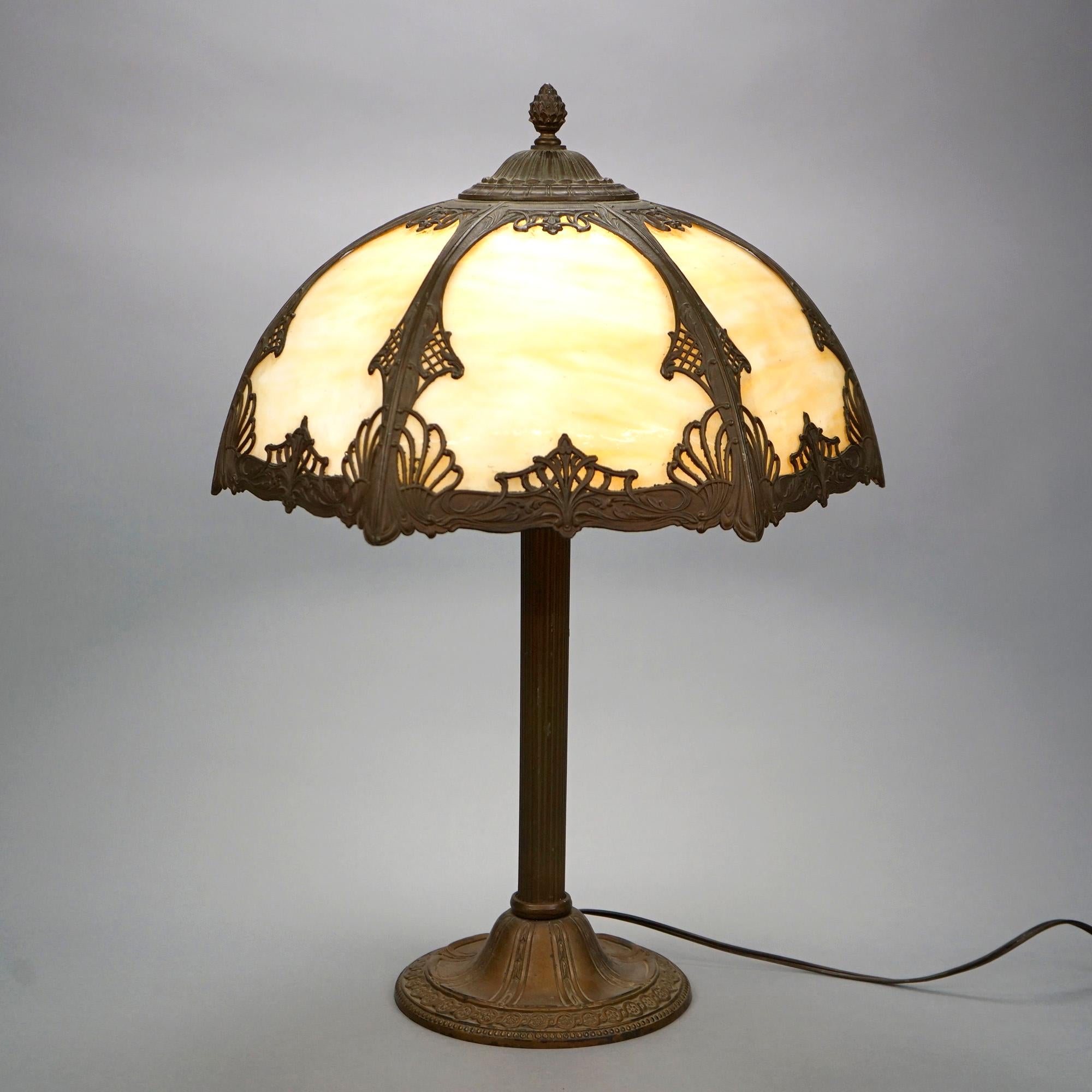 An antique Arts and Crafts table lamp offers dome form cast filigree shade with stylized foliate elements over single socket cast base, c1920.

Measures- 23''H x 14.5''W x 14.5''D.

Catalogue Note: Ask about DISCOUNTED DELIVERY RATES available to