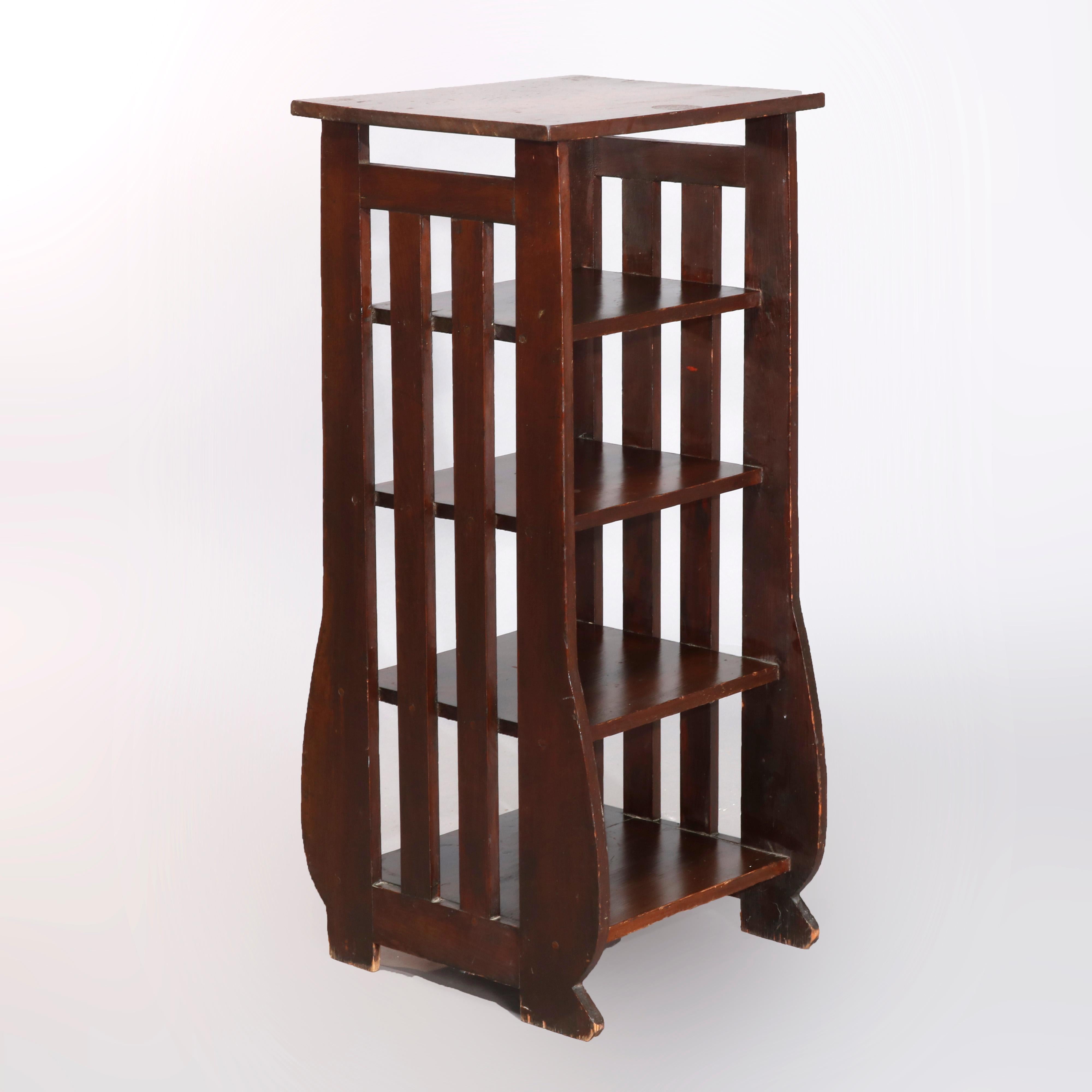 An antique Arts & Crafts magazine stand offers oak slat construction with lyre shaped sides and four shelves, circa 1920

Measures: 42.5