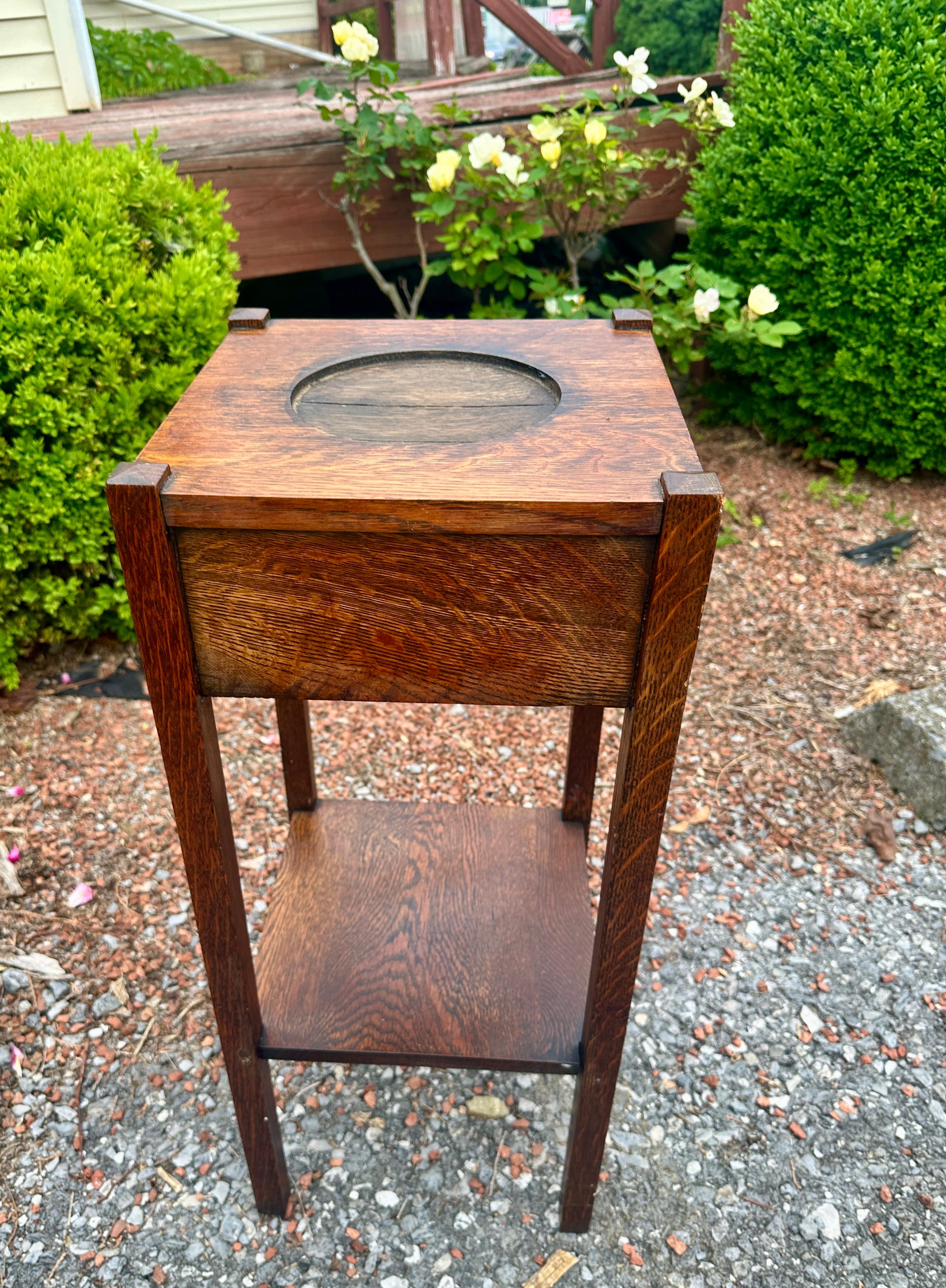 Antique Arts & Crafts Stand c. 1910 

This is an antique smoking stand (planter?) from c. 1910.  It has one drawer and a small shelf on the bottom.  It has the original finish and is in very good condition.  STURDY & STRONG, this stand is ready for