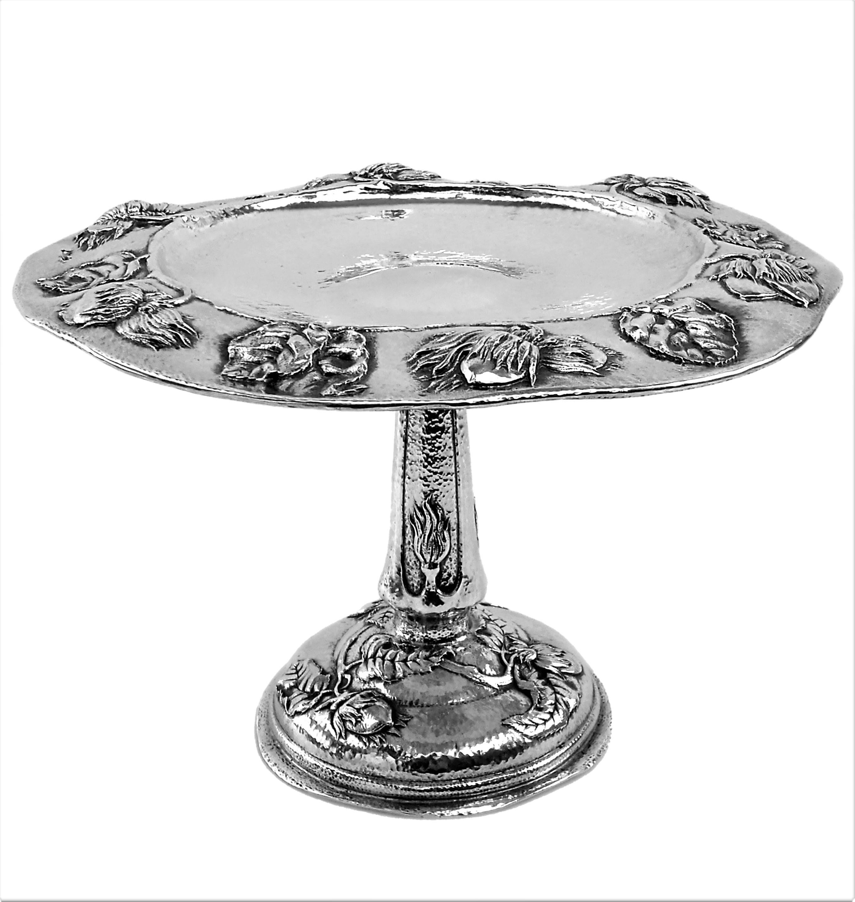 A gorgeous Antique Sterling Silver Arts & Crafts Dish / Tazza Comport with a wide shallow bowl on a tall column and a domed pedestal foot. The body of the Dish is covered in a hammered patterning while the Rim of the Bowl, The central column and the