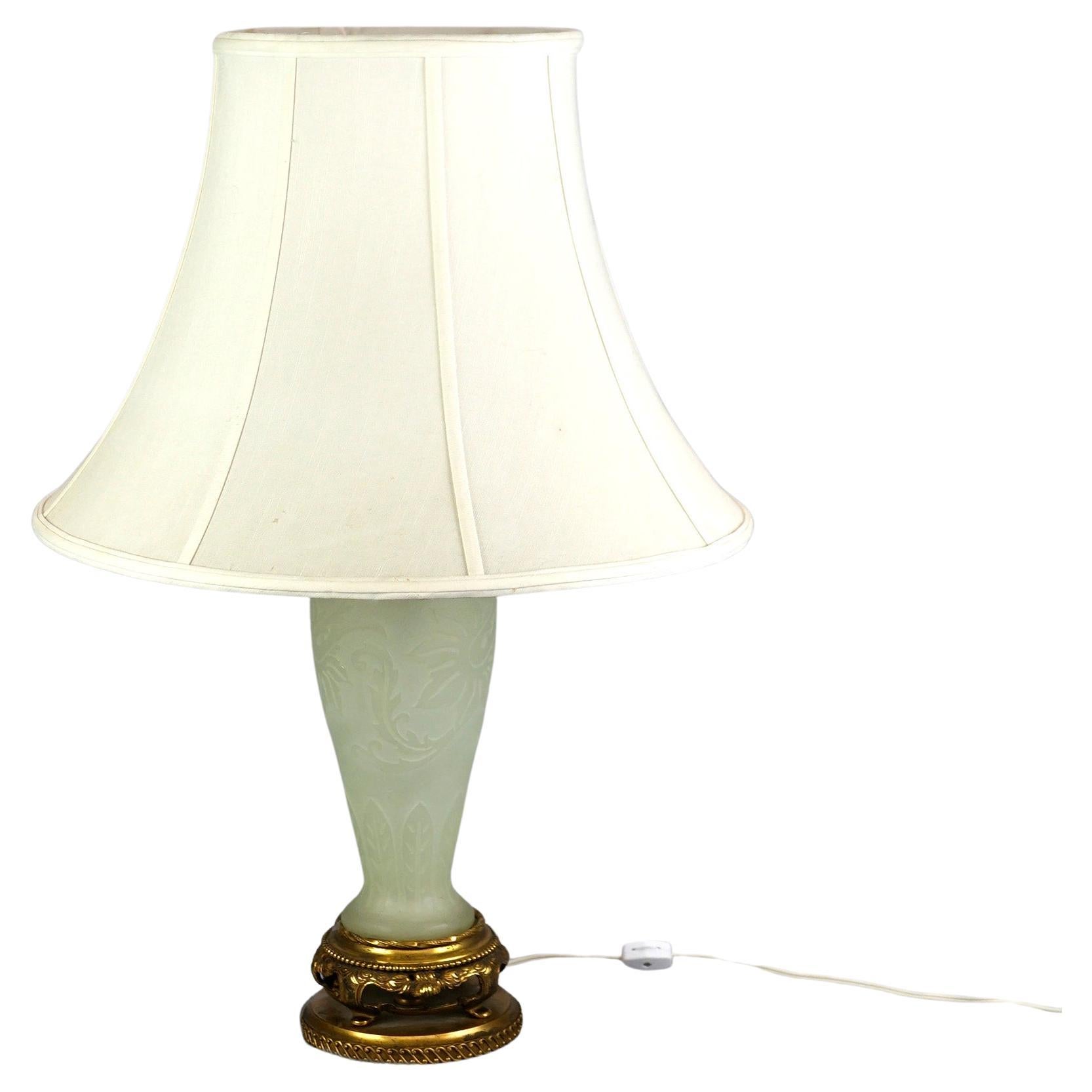 An antique table lamp offers Steuben alabaster art glass construction with cut back floral design, c1920.

Measures- 25.25''H x 5.5''W x 5.5''D; shade 18.25'' diameter.