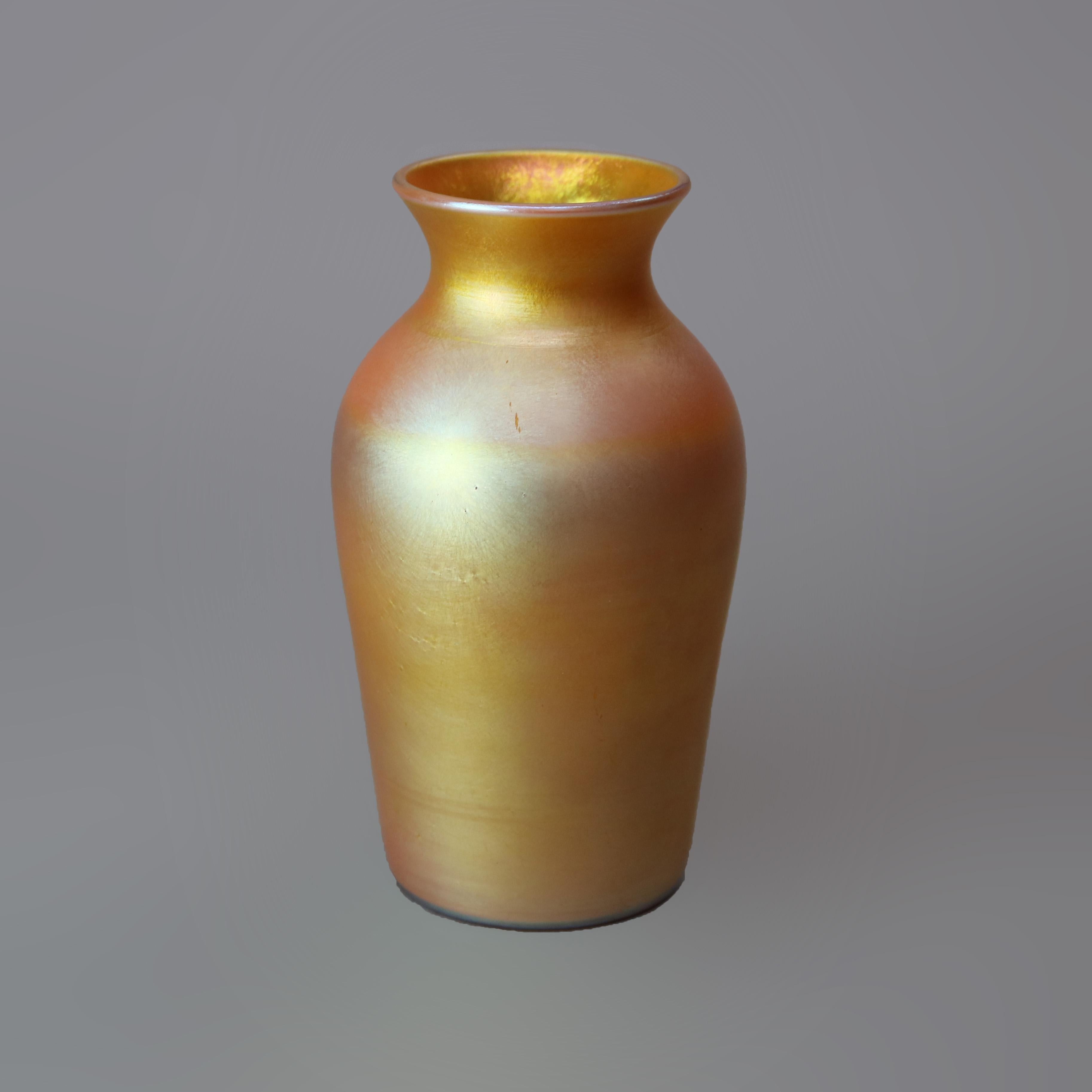 An Arts & Crafts shoulder vase by Steuben offers Gold Aurene mouth blown art glass construction, base signed 