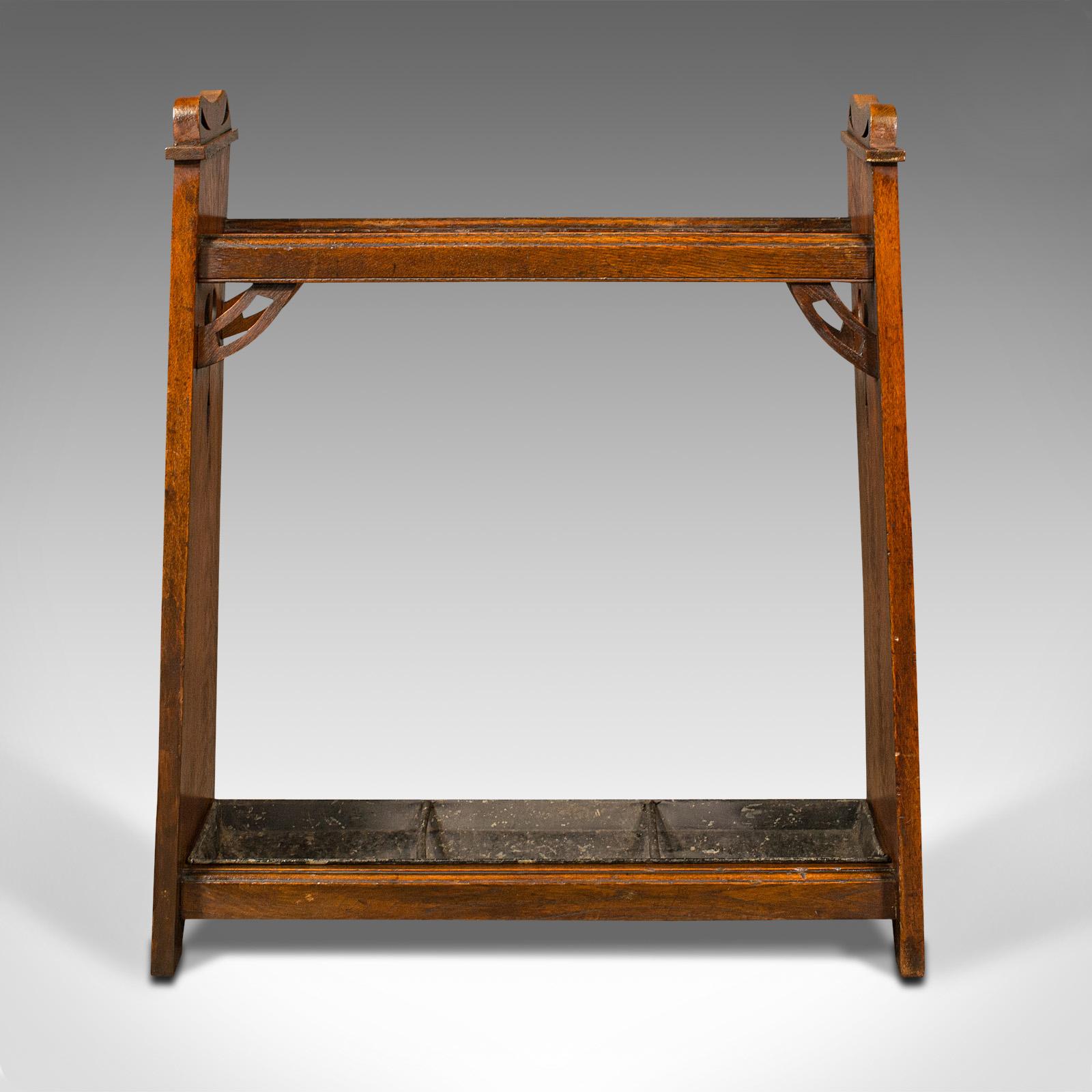 This is an antique Arts & Crafts stick stand. An English, oak hall rack in the manner of Liberty, dating to the Edwardian period, circa 1910.

Striking figuring and appealing Arts & Crafts movement taste
Displays a desirable aged patina and in