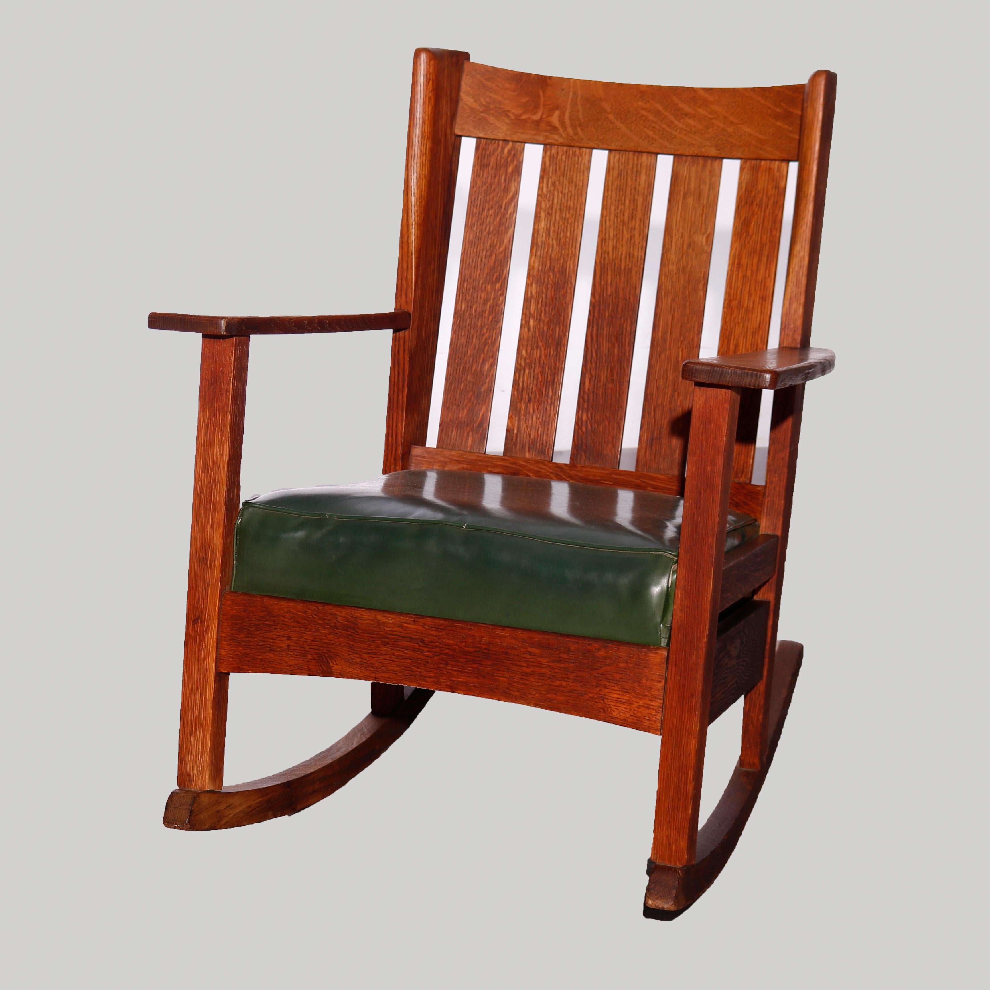 An antique Arts & Crafts Mission set by Stickley Brothers offers wing chair and rocker in oak construction with slat backs and upholstered seats, unsigned, c1910

Measures - rocker 38.5''H x 27.5''W x 24.25''D, seat height 15 1/4