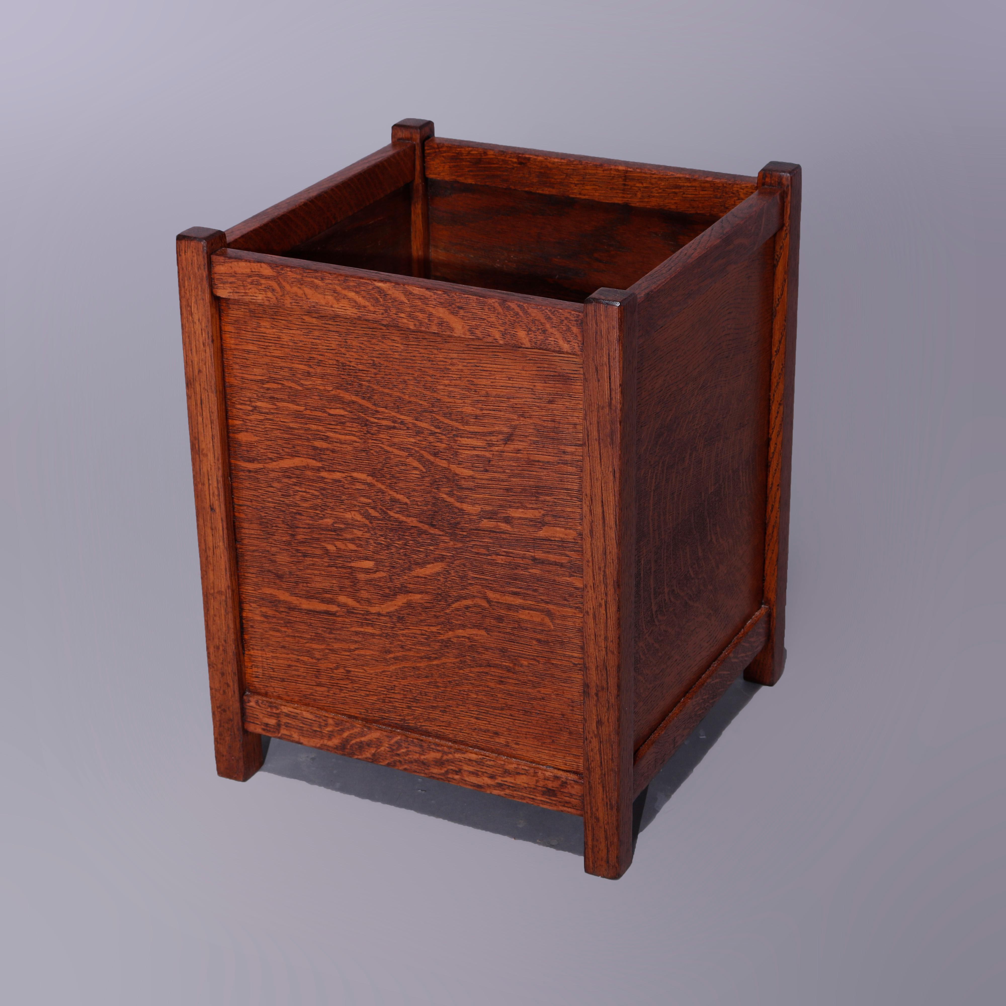 An antique Arts & Crafts waste basket in the manner of Stickley Brothers offers quarter sawn oak construction with four paneled sides raised on square and straight legs, c1910

Measures - 18'' H x 14'' W x 14'' D.