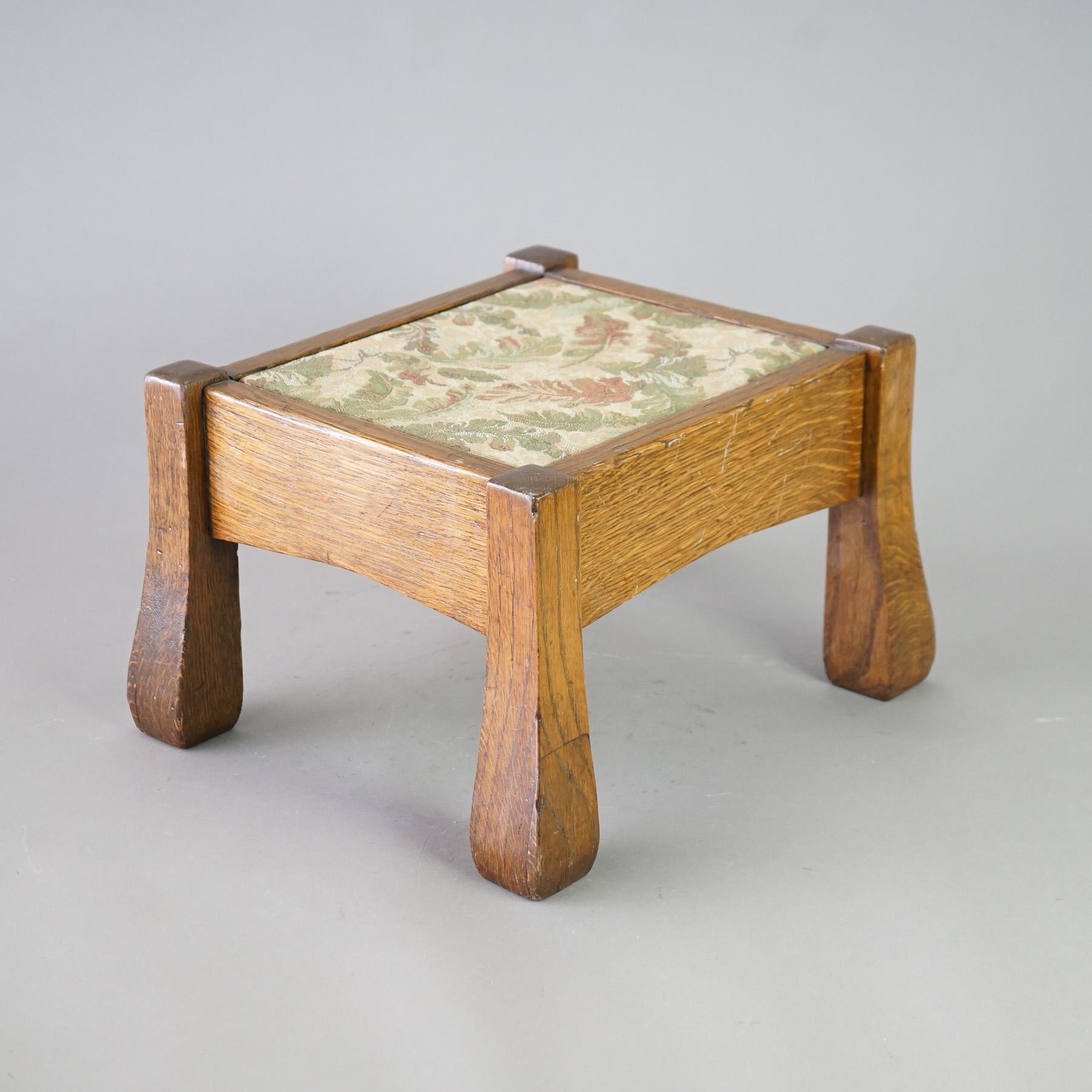 An antique Arts and Crafts footstool attributed to Stickley offers upholstered seat on quarter sawn frame and raised on flared legs, unsigned, c1910

Measures - 10