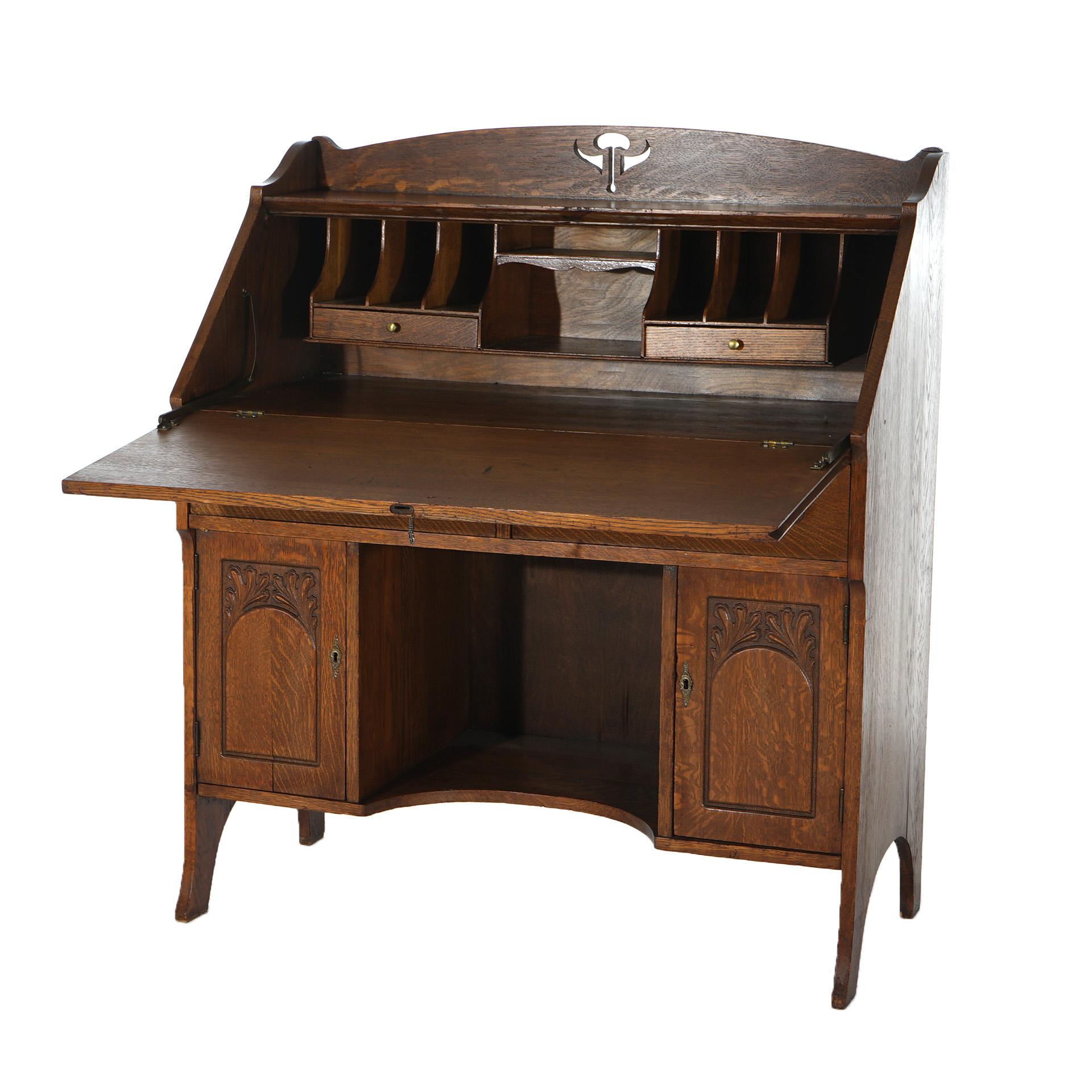 An antique Arts & Crafts drop front desk in the manner of Stickley offers oak construction with cutout backsplash and foliate carved cabinet doors, c1920

Measures- 44''H x 38.25''W x 18.75''D