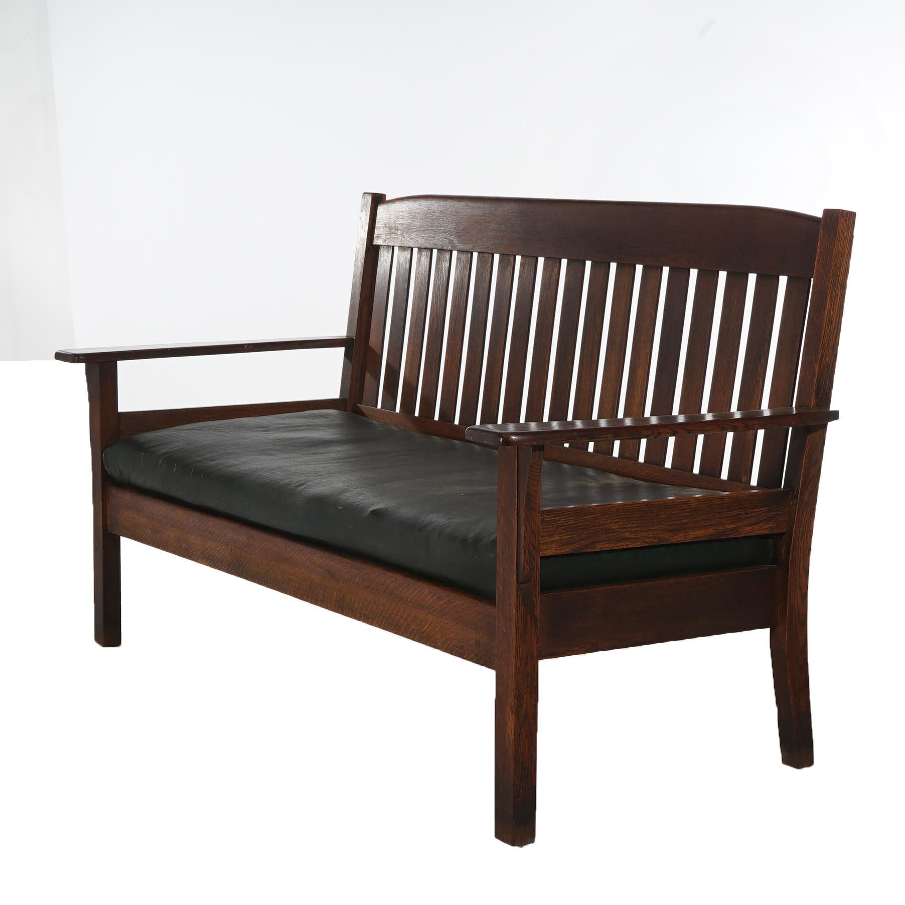 ***Ask About Reduced In-House Shipping Rates - Reliable Service & Fully Insured***
An antique Arts and Crafts Mission long bench in the manner of Stickley offers oak construction with slat back and seat, raised on square and straight legs; maker