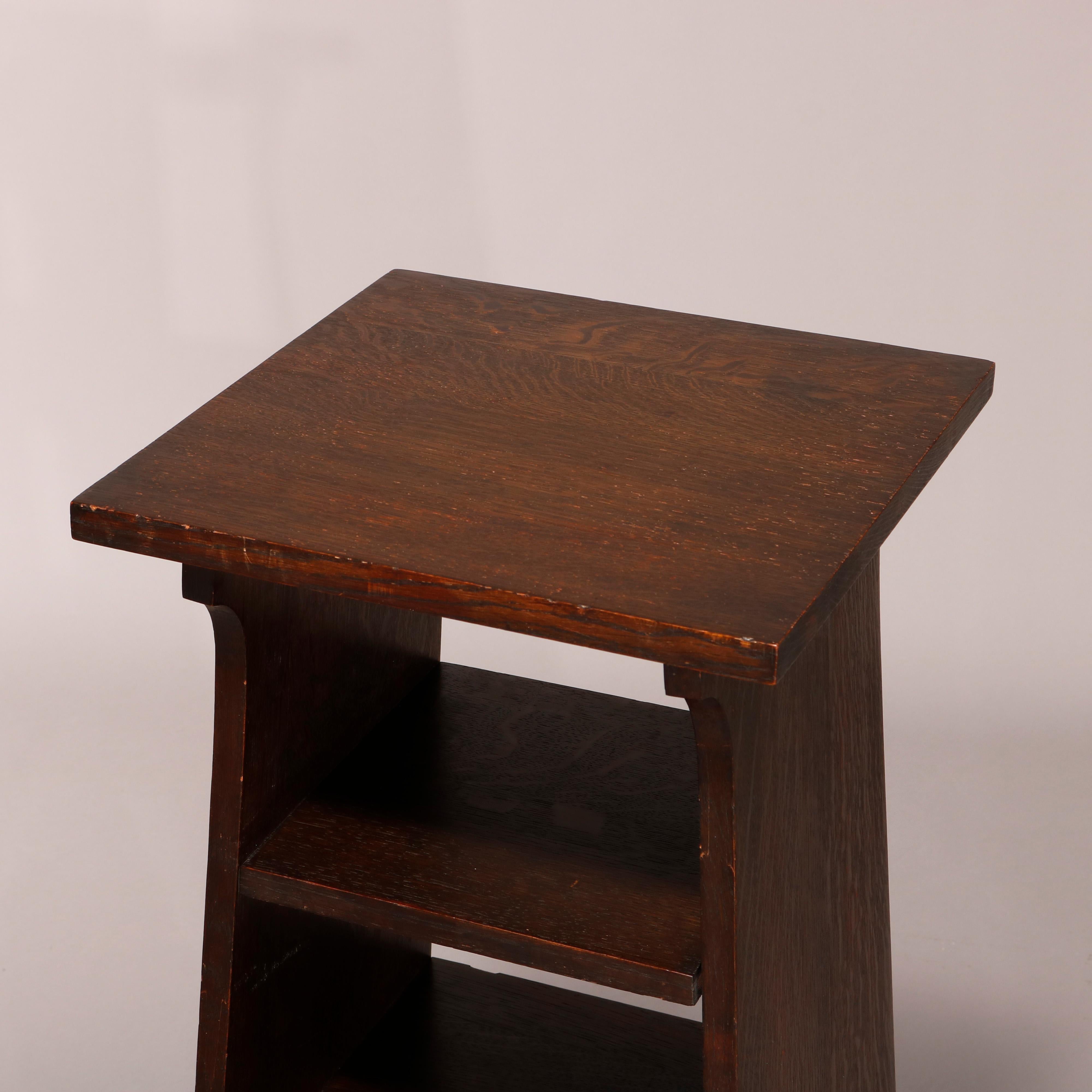 An antique Arts & Crafts magazine stand in the manner of Stickley for Tobey School offers oak construction with tapered slat sides with cutout legs, c1910

Measures: 36