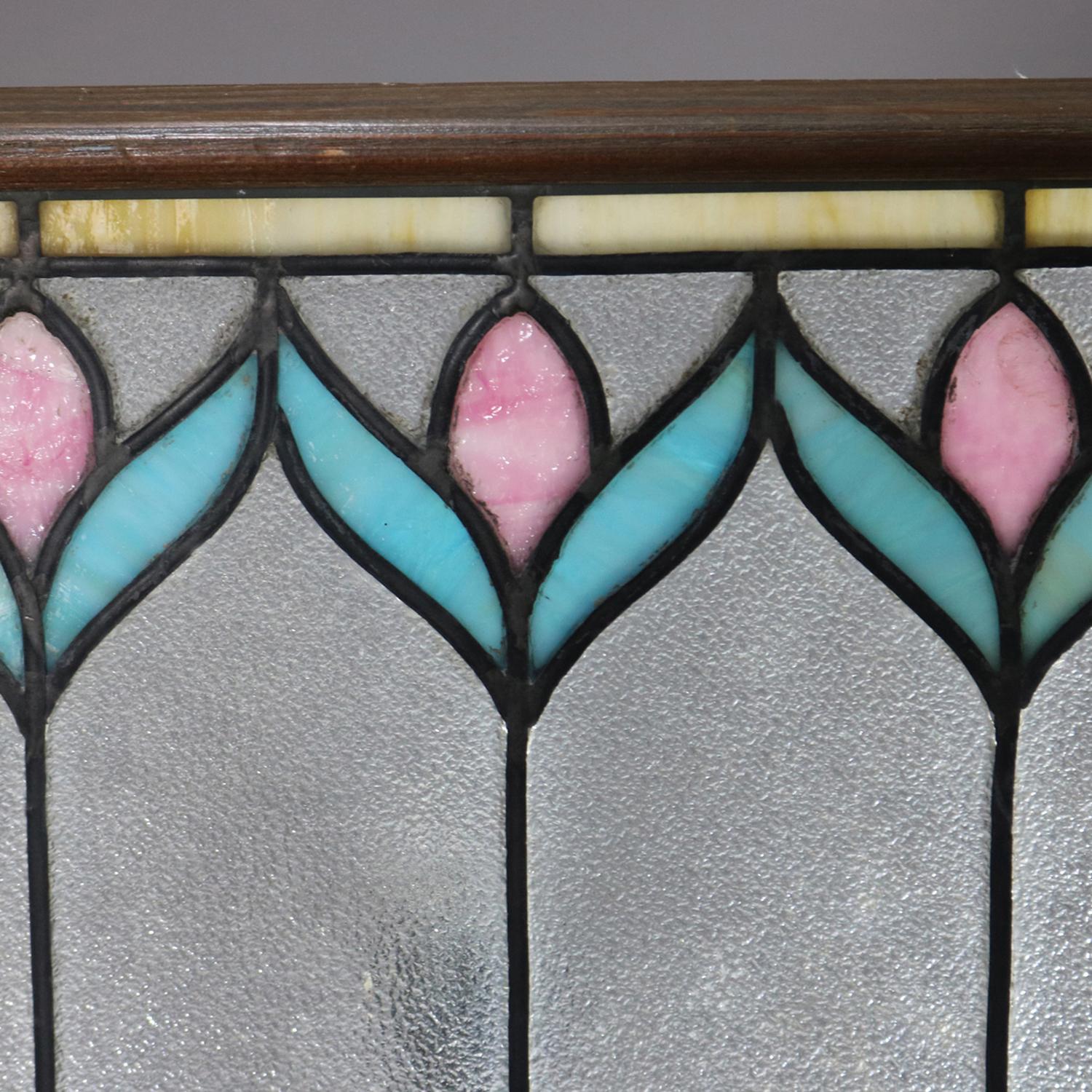 An antique Arts & Crafts window features leaded slag glass repeating stylized flower design, seated in frame, circa 1910.

***DELIVERY NOTICE – Due to COVID-19 we are employing NO-CONTACT PRACTICES in the transfer of purchased items.  Additionally,