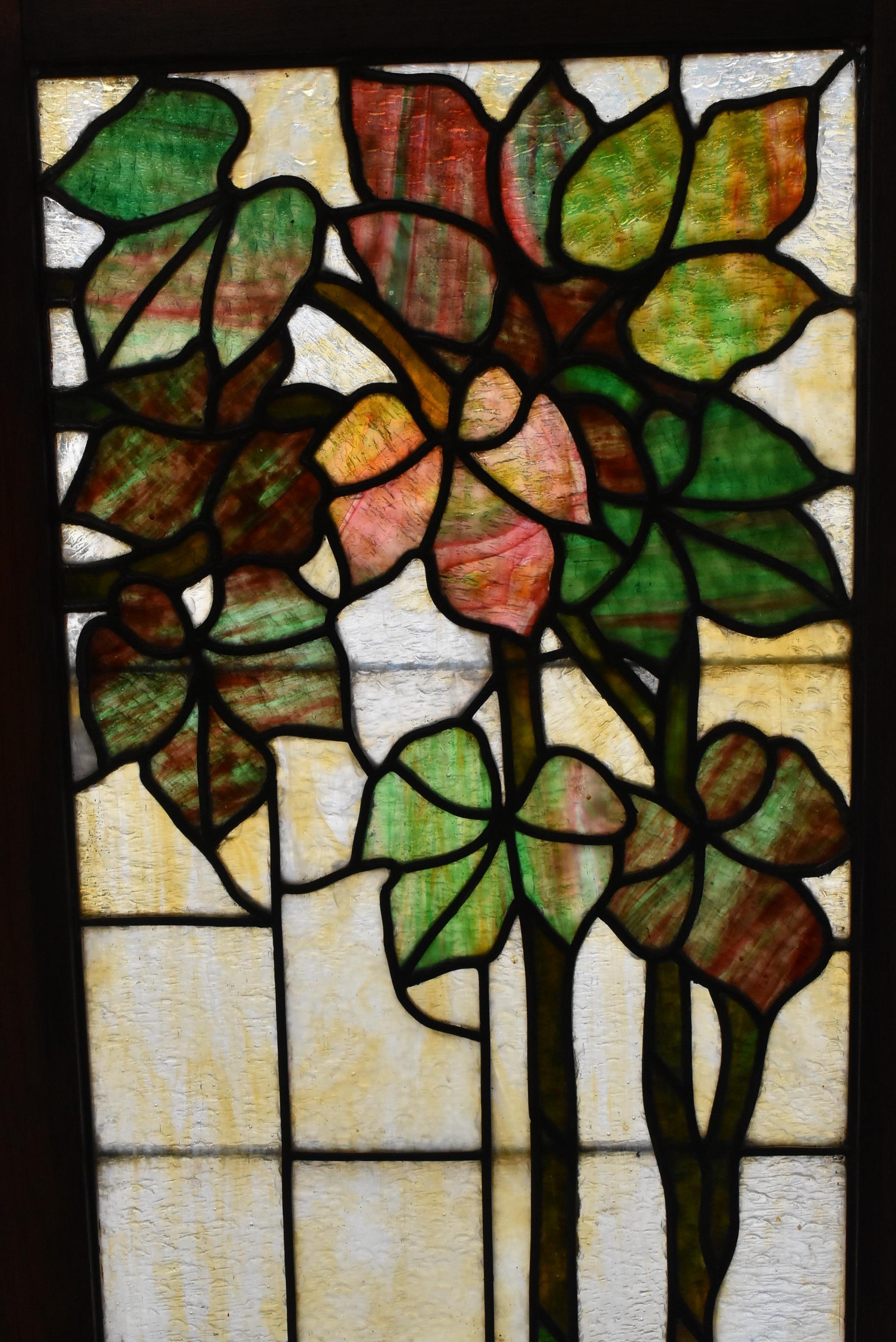 Antique turn of the century three-piece stained glass panels with grape leaf trellis design. Heavy granite back. New frames in oak.