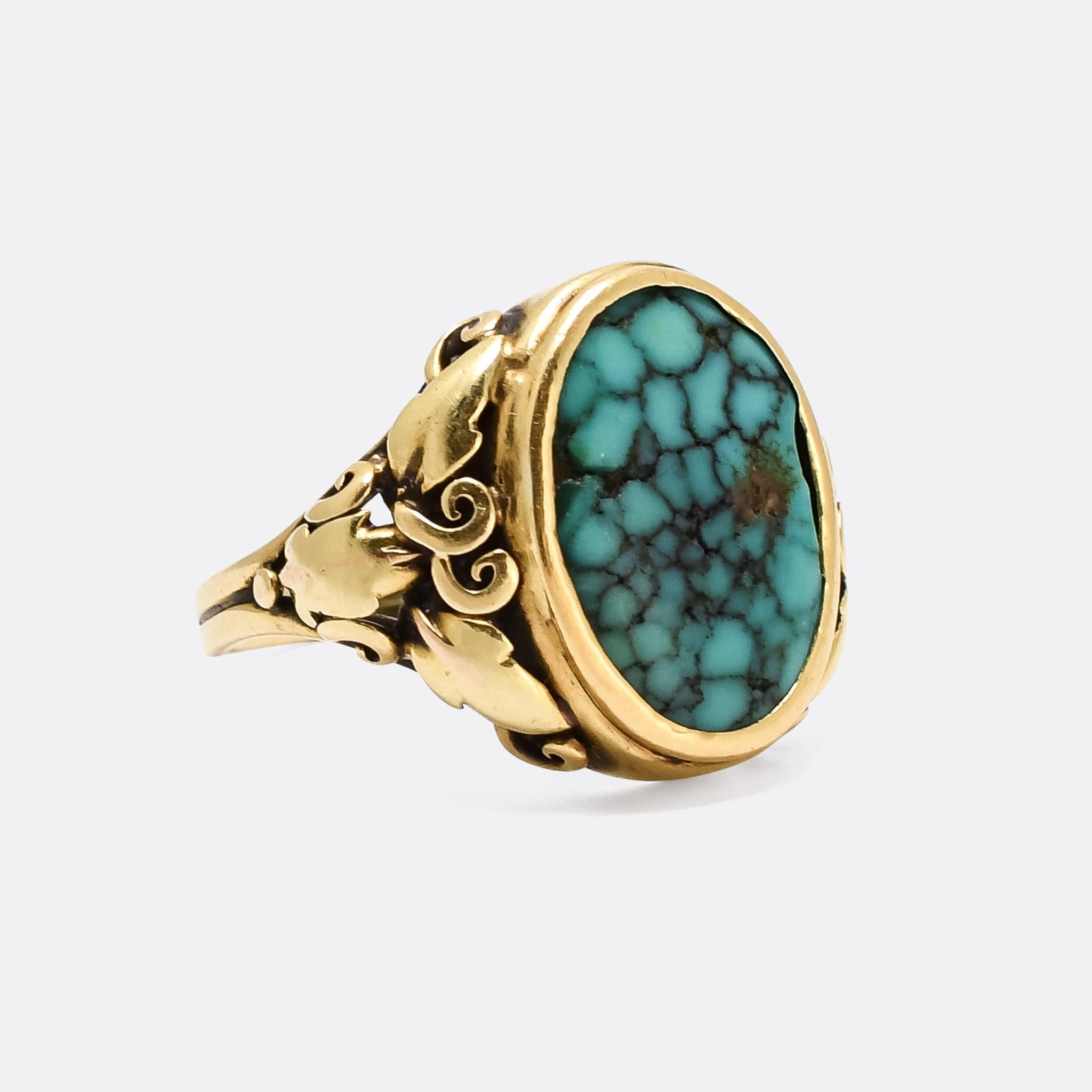 A fantastic early Arts & Crafts signet ring dating from the latter half of the 19th century, circa 1880. It's set with a beautiful oval turquoise matrix, cut as a shallow cabochon, with wonderfully intricate grape vine and leaf shoulder detailing.