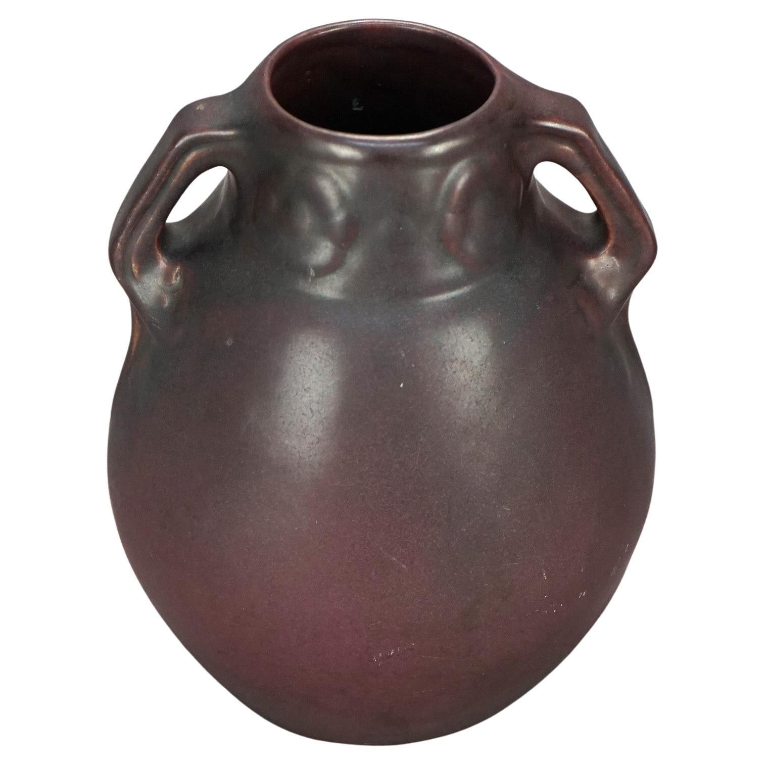 An antique Arts & Crafts vase by Van Briggle offers art pottery construction in bulbous form and having two flanking handles, maker signed on base as photographed, c 1920.

Measures: 12.5' 'H x 4'' W x 5.25'' D.