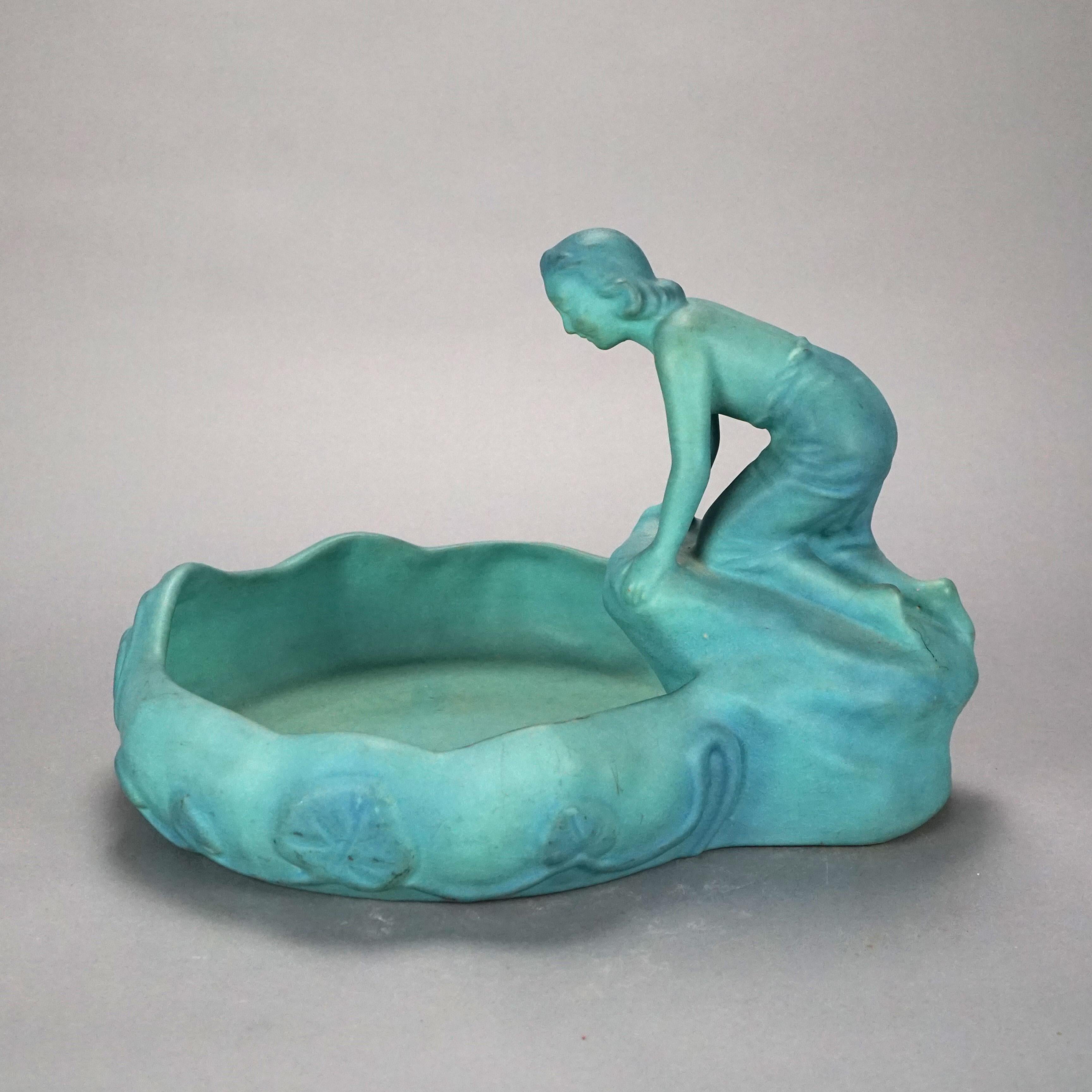 An antique Arts and Crafts figural Lady of the Lake dish by Van Briggle offers art pottery construction with young woman lakeside, maker mark on base as photographed, c1920

Measures- 10.25''H x 14.75''W x 12''D.