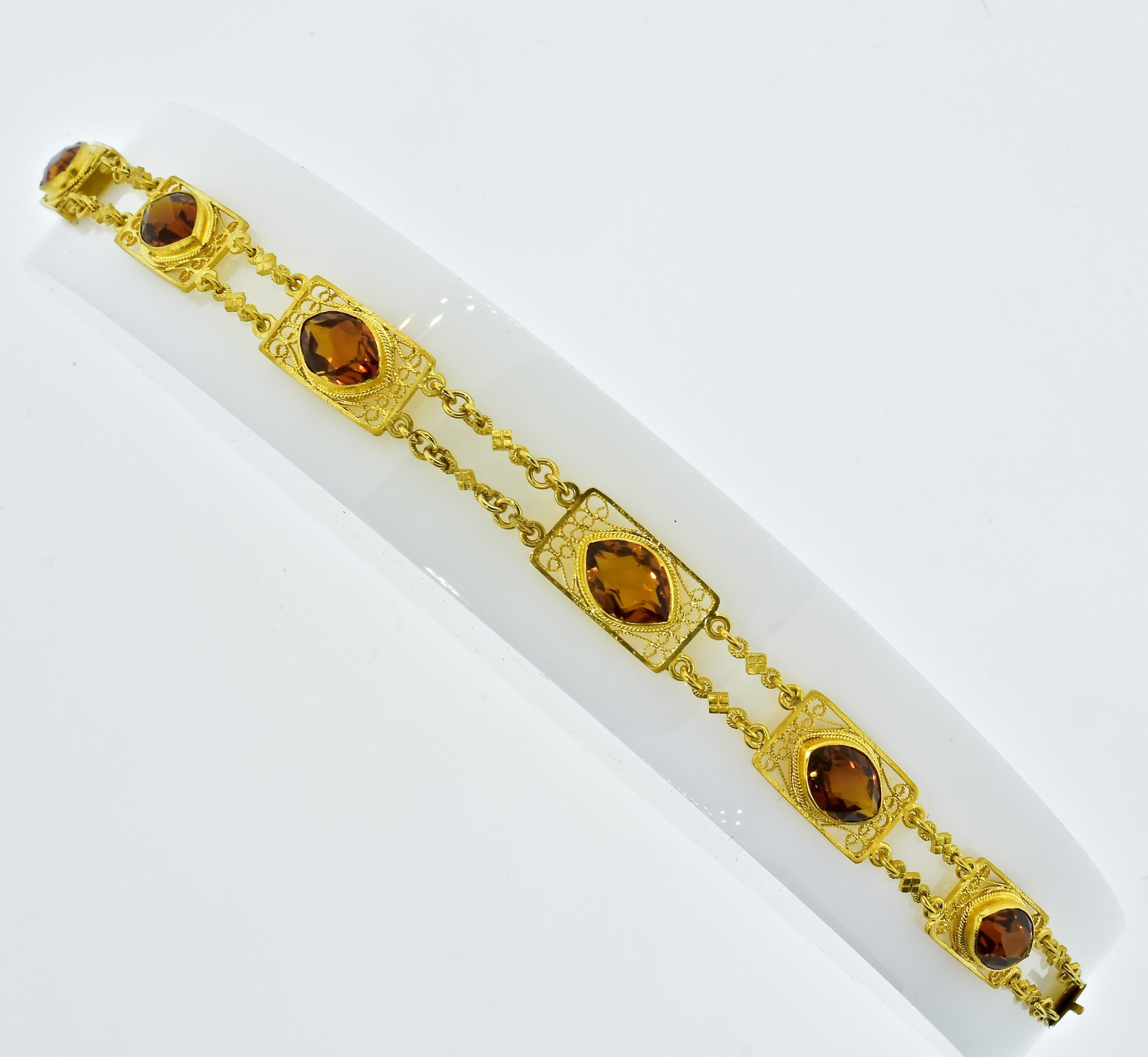 Antique, Arts & Crafts Era, hand made bracelet possessing 6 marquis cut natural deep orange citrines.  Often called Madeira-colored Citrine, these stones, weighing totally approximately 15 cts., are all well matched with fine vibrant clear color. 