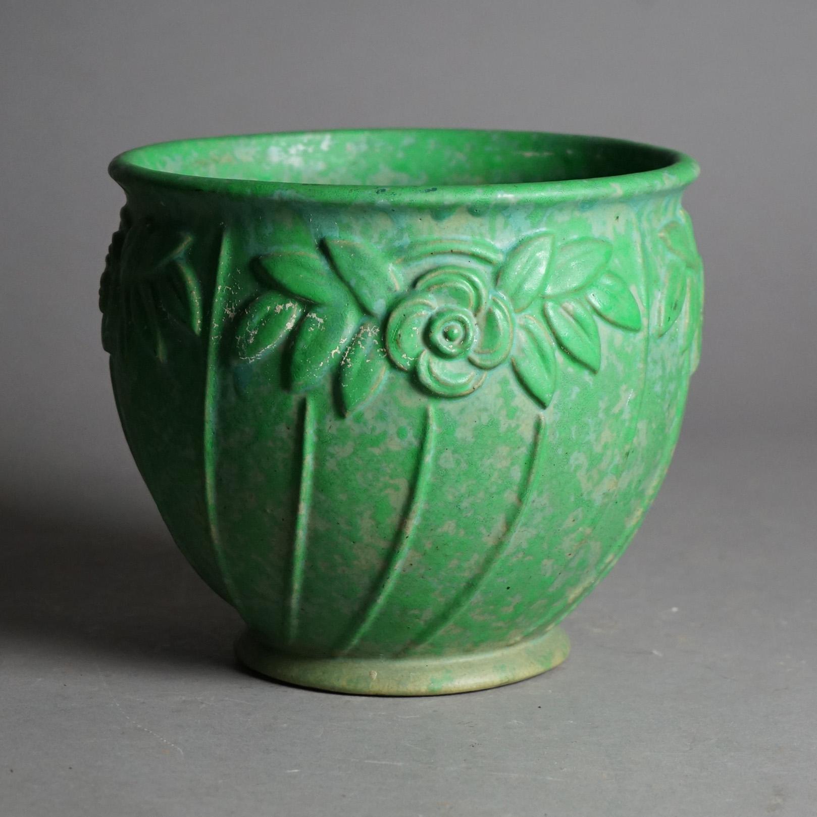 An antique Arts and Crafts jardiniere by Weller offers glazed art pottery construction with embossed flower patter, c1920

Measures - 7.75