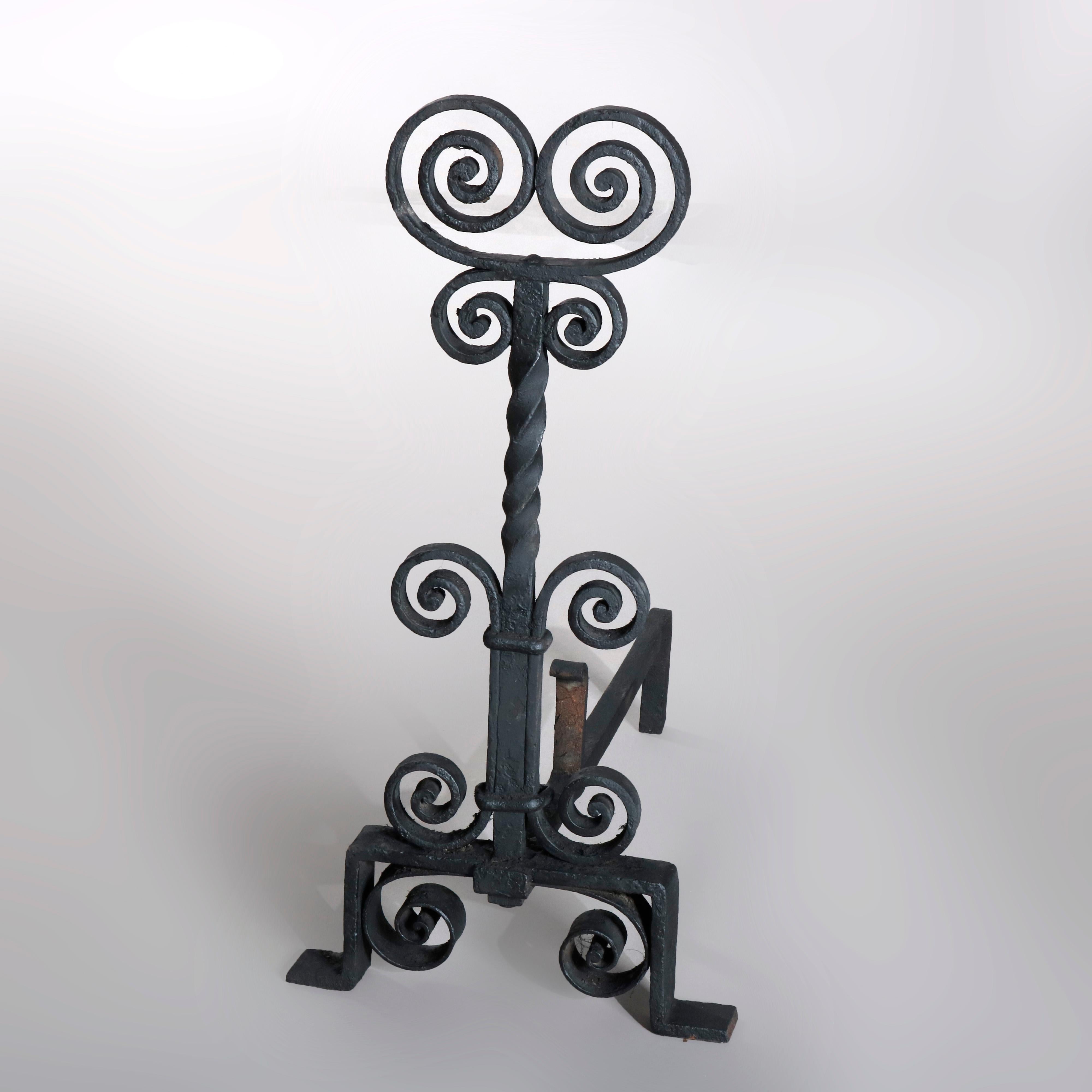 An antique pair of Arts & Crafts Yellin School andirons offer wrought iron construction with double scroll finials surmounting twisted shaft with scroll decoration, circa 1910

Measures: 23.5