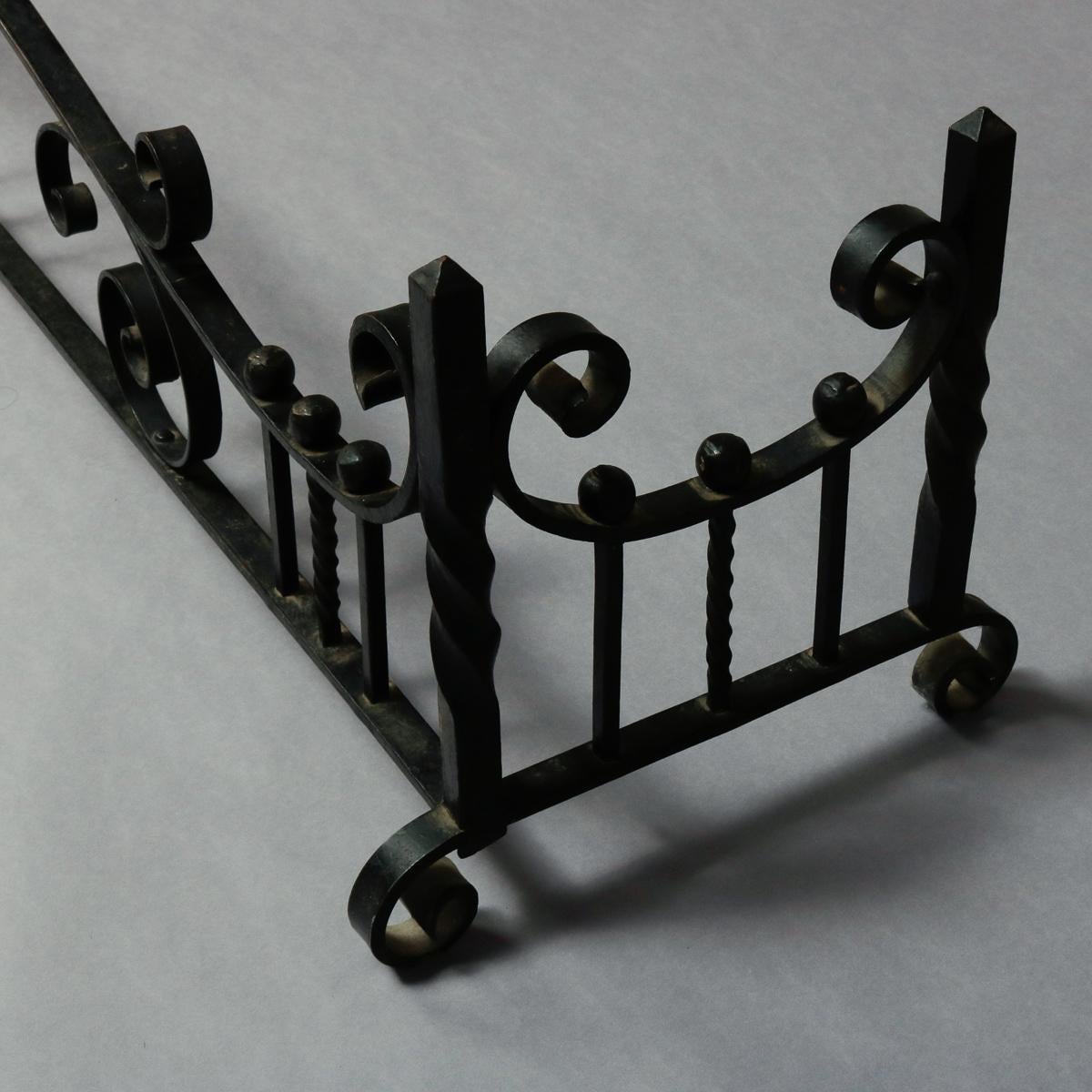 An antique Arts & Crafts Yellin school fireplace fender offers wrought iron construction with scroll and ball and twisted post work, raised on scroll form feet, circa 1910

***DELIVERY NOTICE – Due to COVID-19 we are employing NO-CONTACT PRACTICES