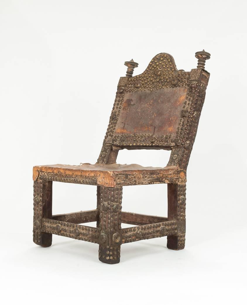 A very cool, small chair with studs and carving from Ghana. More like a power object than a functional chair. 