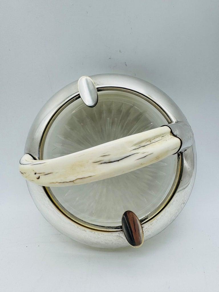 Antique ashtray made of silver plated and cut glass with boar teeth, 20. Century, approx. 1910

Antique British cigar ashtray made of silver sheet and cut glass from the early 20th century. The smooth edge is provided with three cigar supports. A