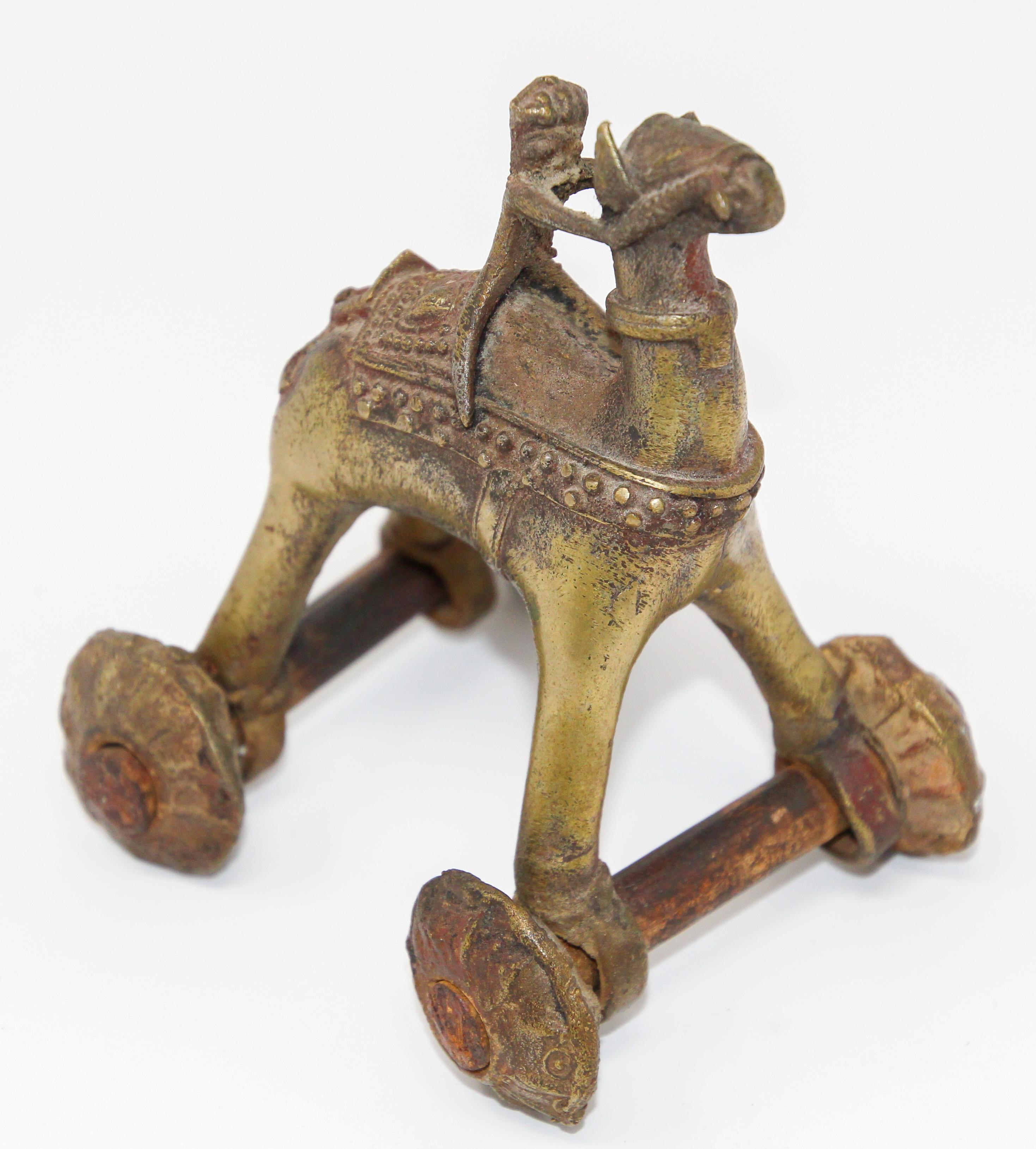 Inspired by a scene from Ramakian or Ramayan, the Indian epic Rama and Sita.
Antique Indian Temple Toy bronze camel on wheels.
Antique hindu bronze temple camel with rider statue toy on wheels.
Commonly known as 