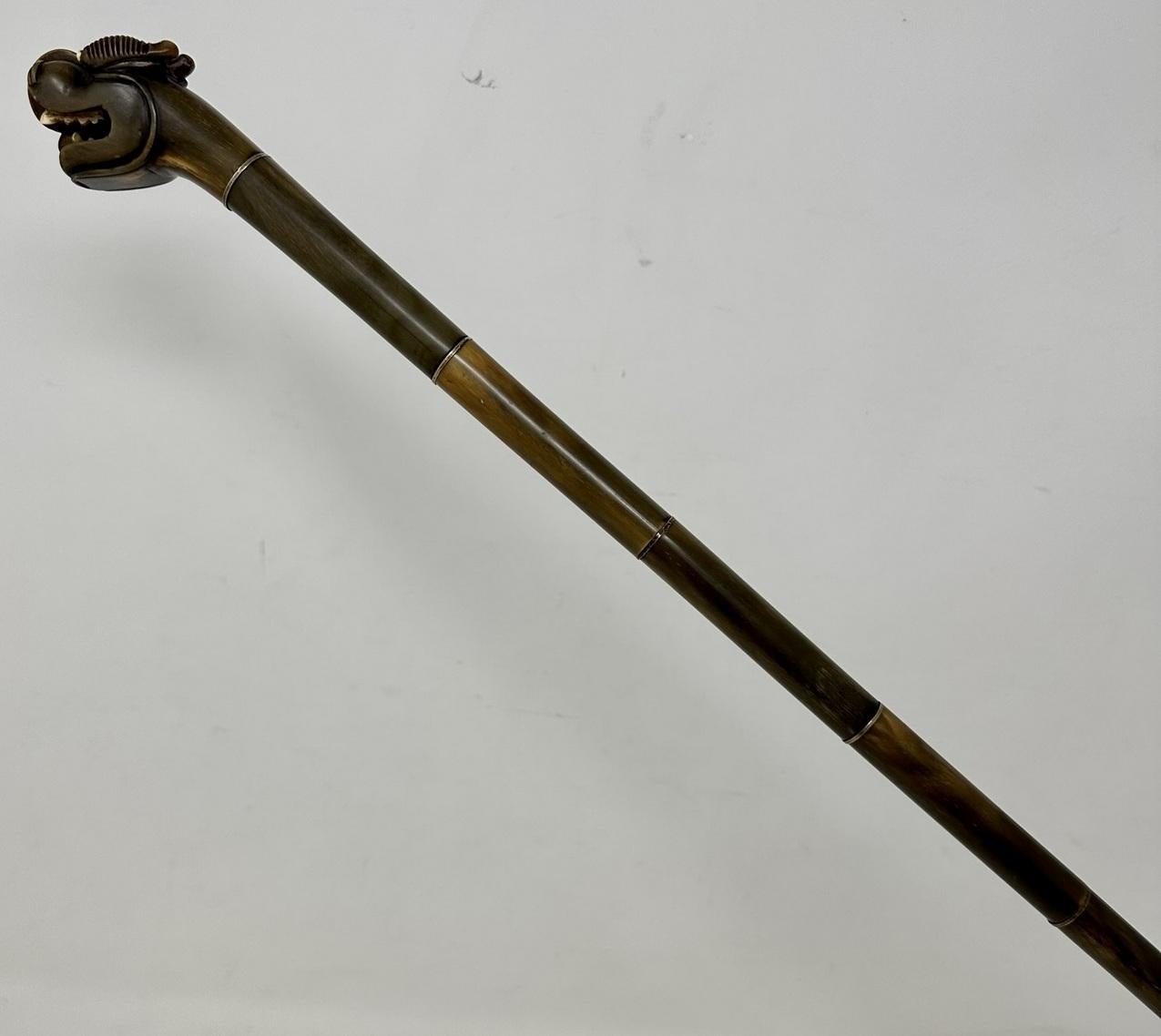 Very Unusual Horn Sectional Hand Carved Chinese Walking Stick or Dress Cane of outstanding quality, last half of the Nineteenth Century. 

The entire shaft is constructed with assembled various length bovine sections with a polished brass ring