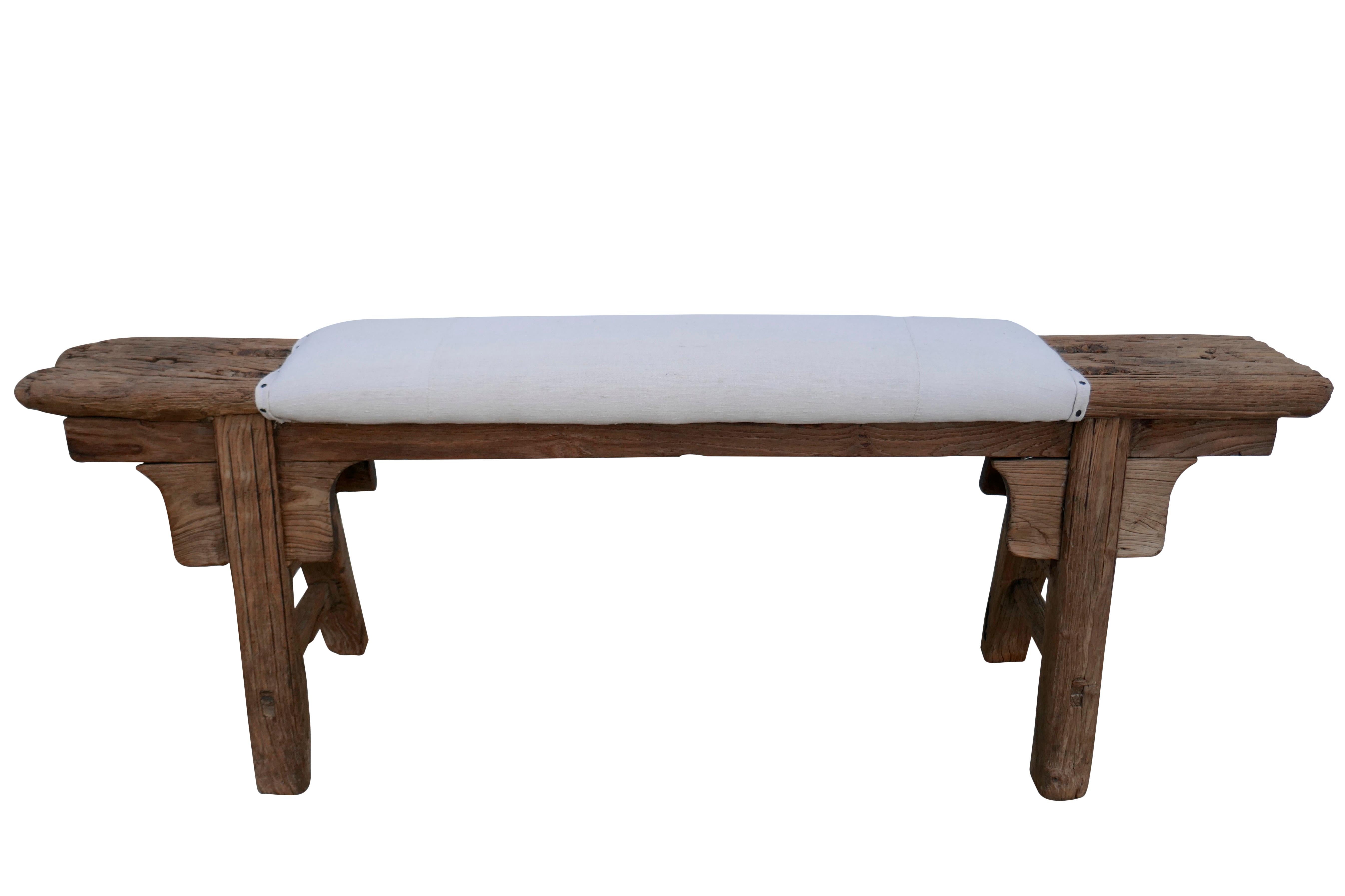 One-of-a-kind authentic antique Asian elmwood bench, upholstered in authentic vintage French hand-spun pure linen in natural tone. Primitively hand-built with mortise & tenon joinery, showing much desirable natural age character and patina.