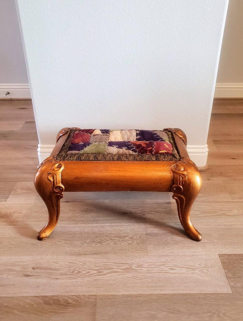 A magnificent, rare and wonderfully unique Asian antique gilded bronze cast iron ottoman footstool. Rich, luxurious gilt bronze rose gold color, later added patchwork upholstery top, elegantly rising on nicely curved cabriole style legs, almost